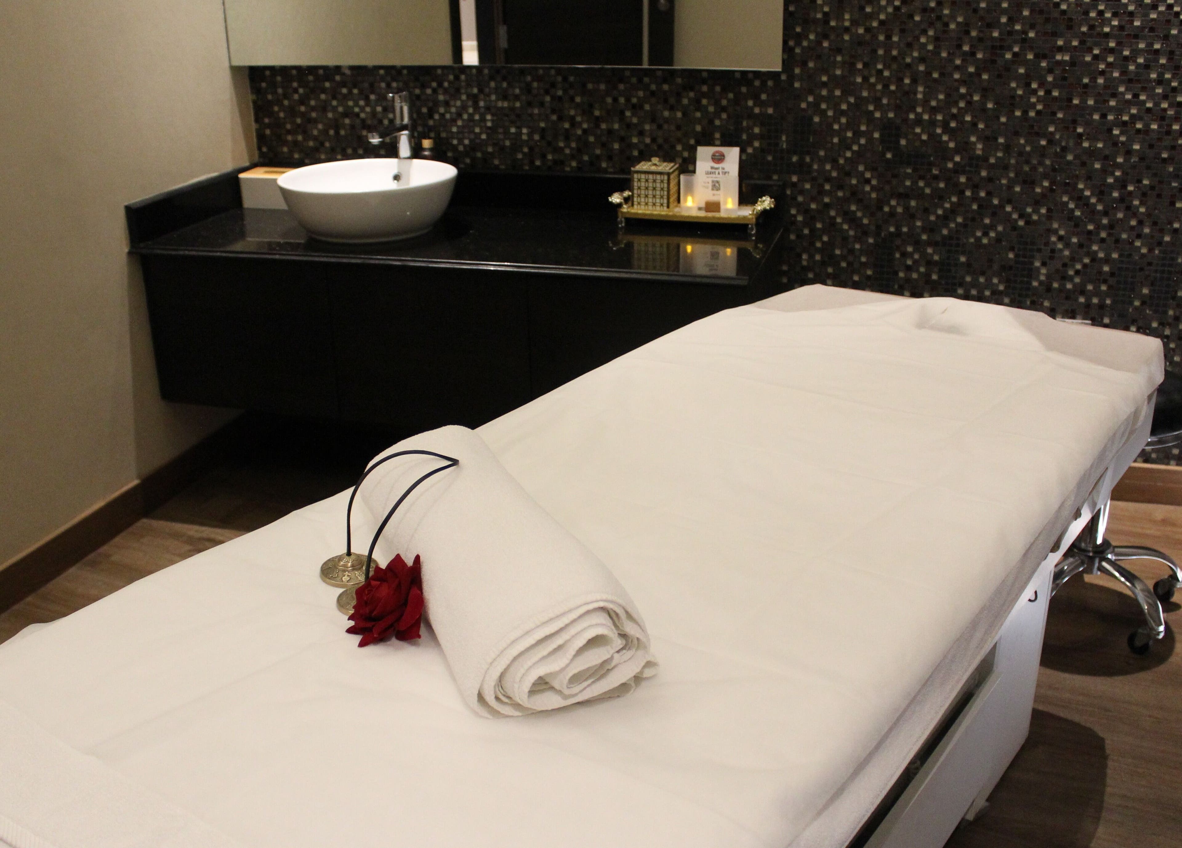 Tranquil spa room at DWS-Radisson Canal View, Dubai, Dubai, AE with massage bed and calming decor.
