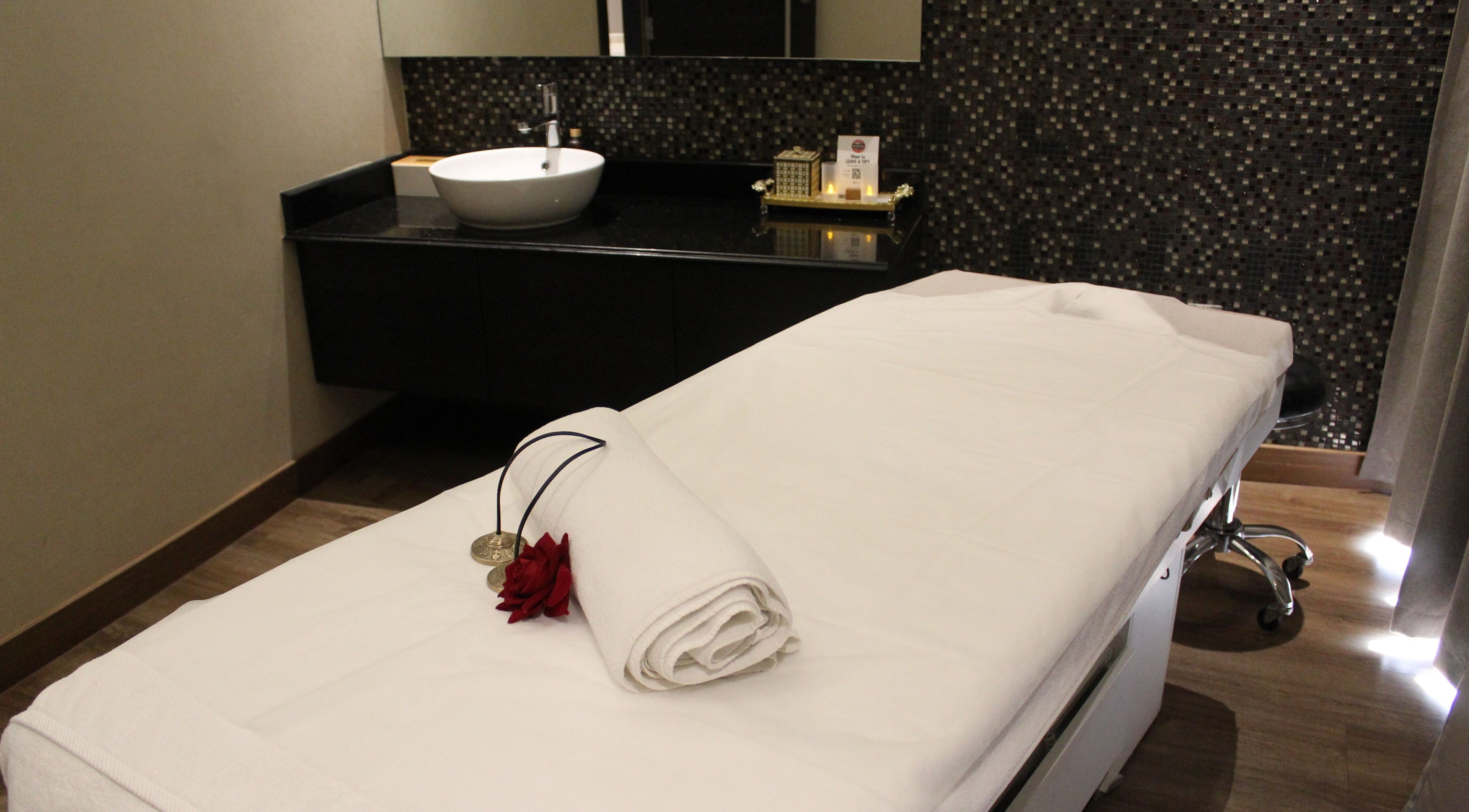 Tranquil spa room at DWS-Radisson Canal View, Dubai, Dubai, AE with massage bed and calming decor.
