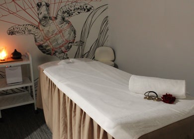 Calming massage room at DWS-Radisson Red Silicon Oasis, Dubai, AE, featuring cozy decor and warm lighting.