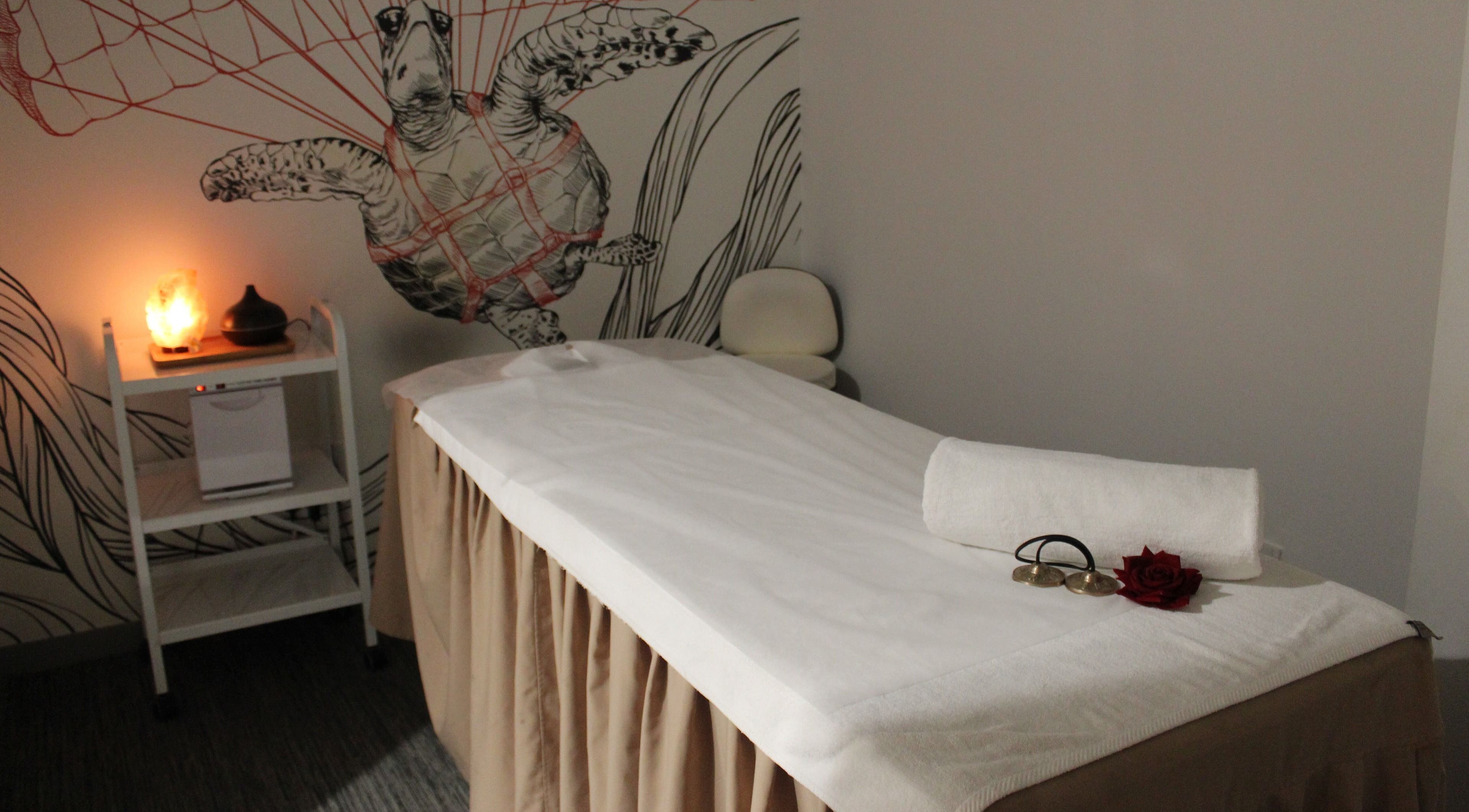 Calming massage room at DWS-Radisson Red Silicon Oasis, Dubai, AE, featuring cozy decor and warm lighting.