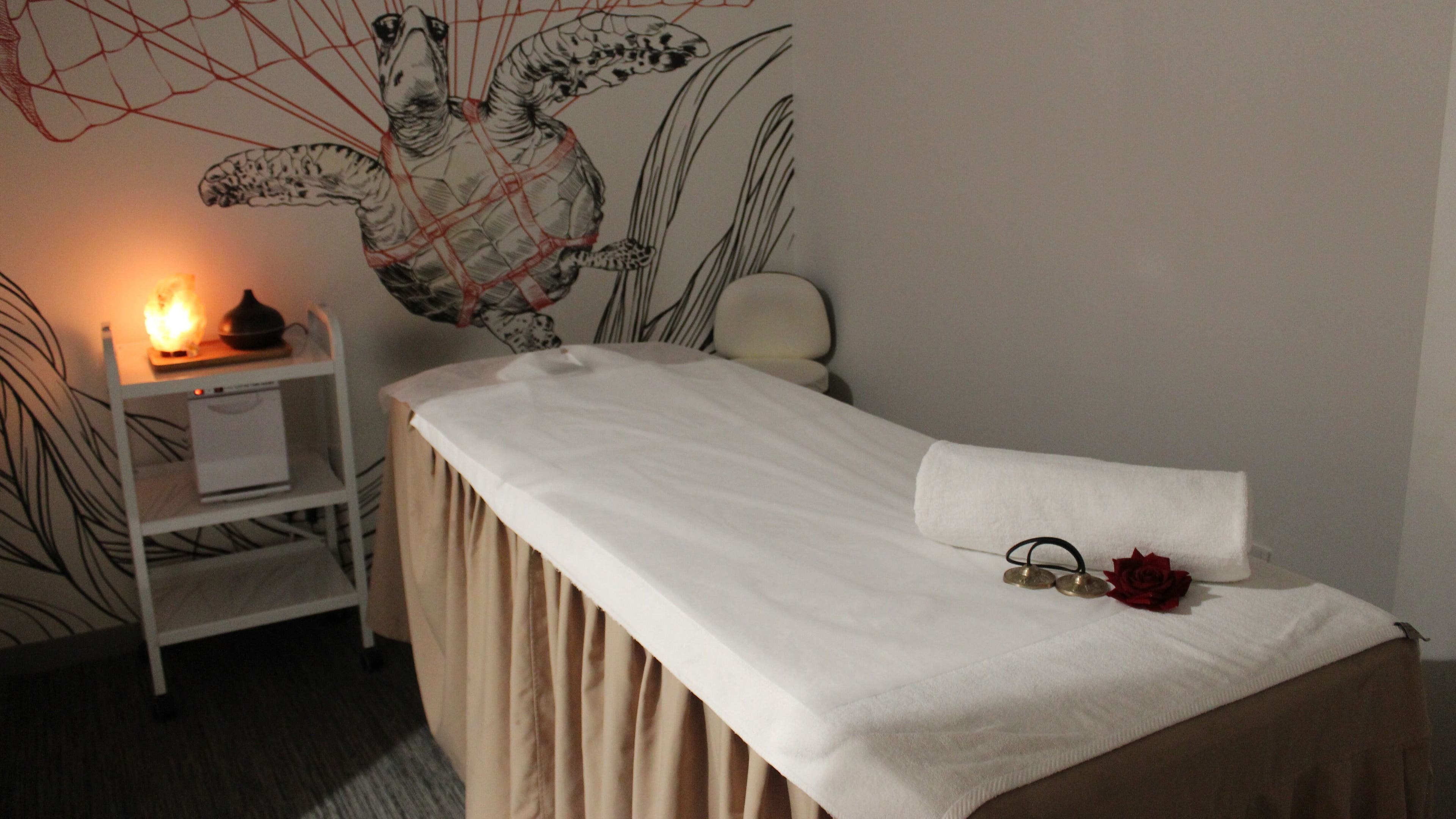Calming massage room at DWS-Radisson Red Silicon Oasis, Dubai, AE, featuring cozy decor and warm lighting.