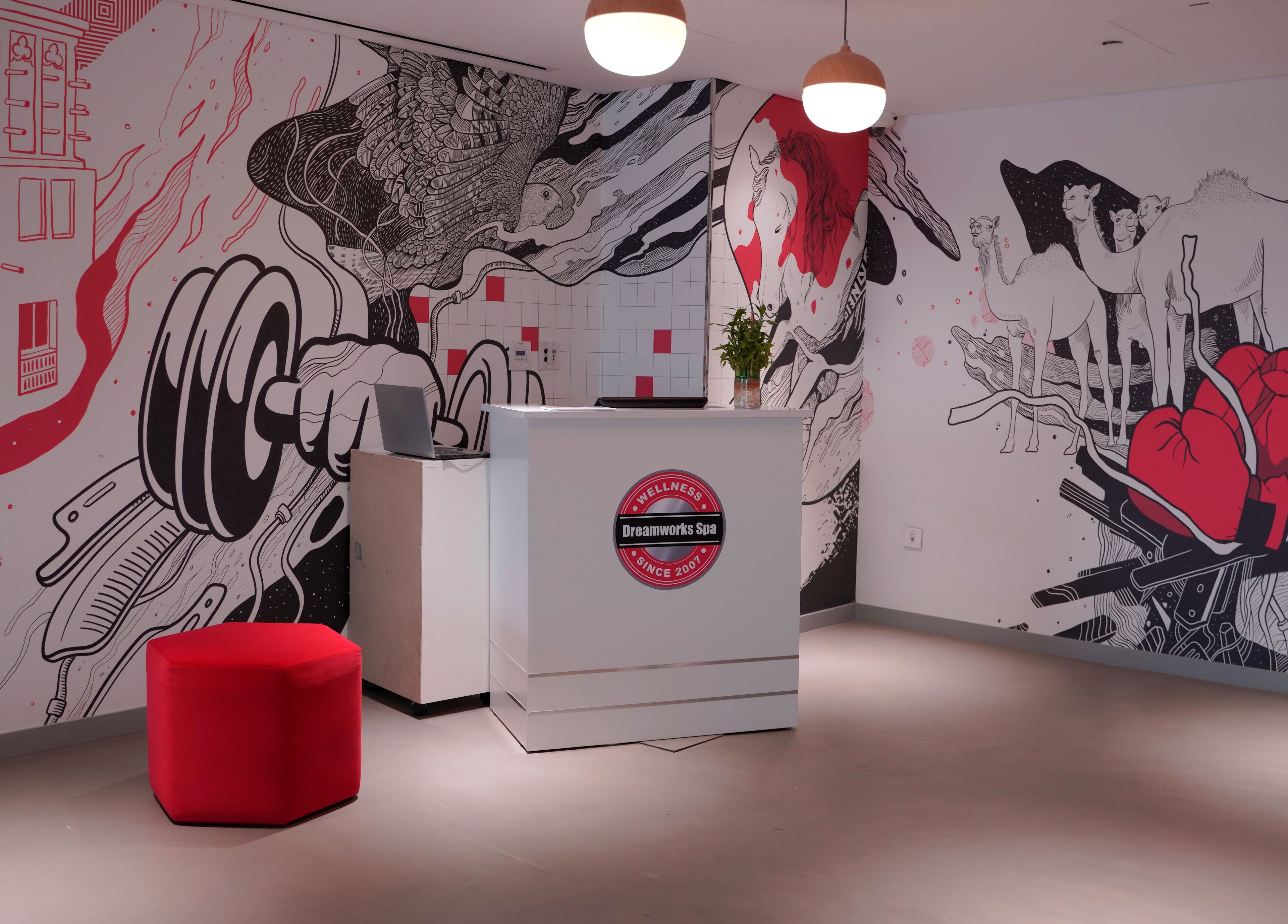 Artistic lobby of DWS-Radisson Red Silicon Oasis in Dubai, AE featuring bold mural and modern décor.