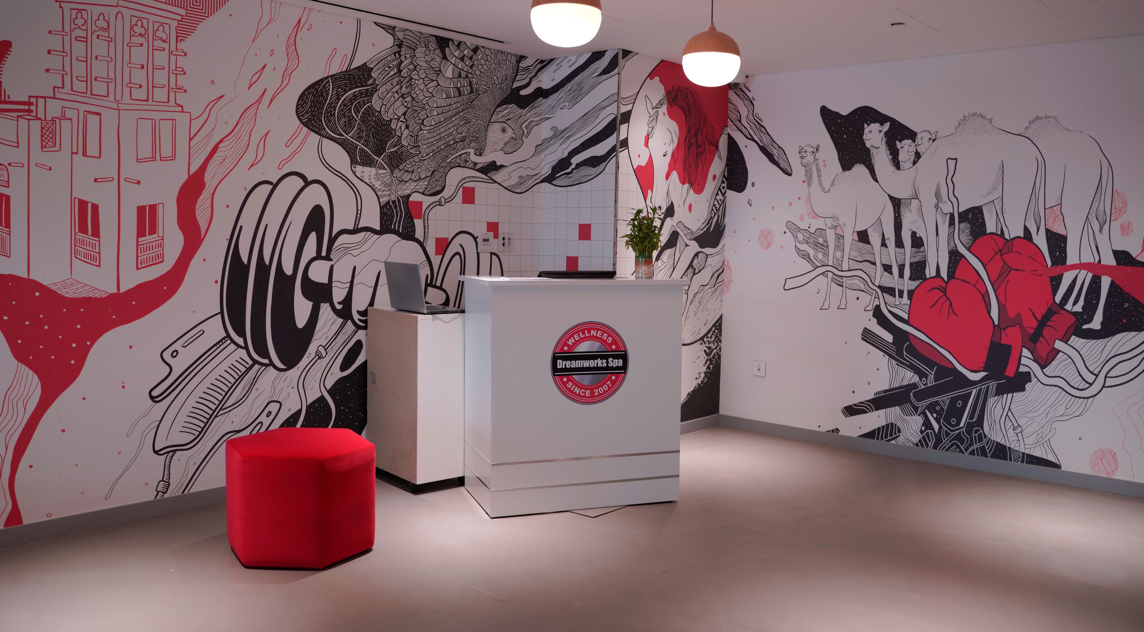 Artistic lobby of DWS-Radisson Red Silicon Oasis in Dubai, AE featuring bold mural and modern décor.