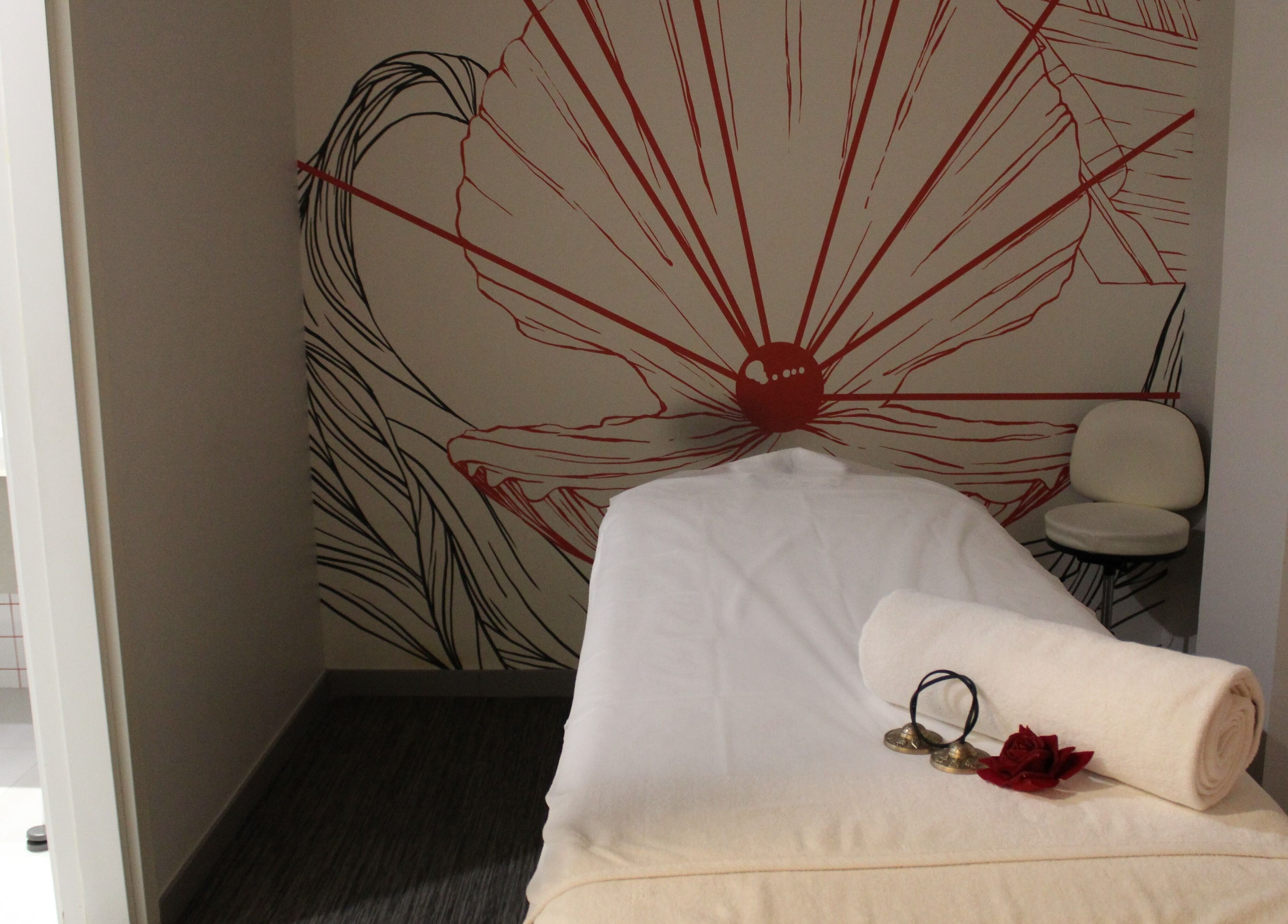 Tranquil spa room at DWS-Radisson Red Silicon Oasis in Dubai, Dubai, AE, featuring a massage table and floral decor.