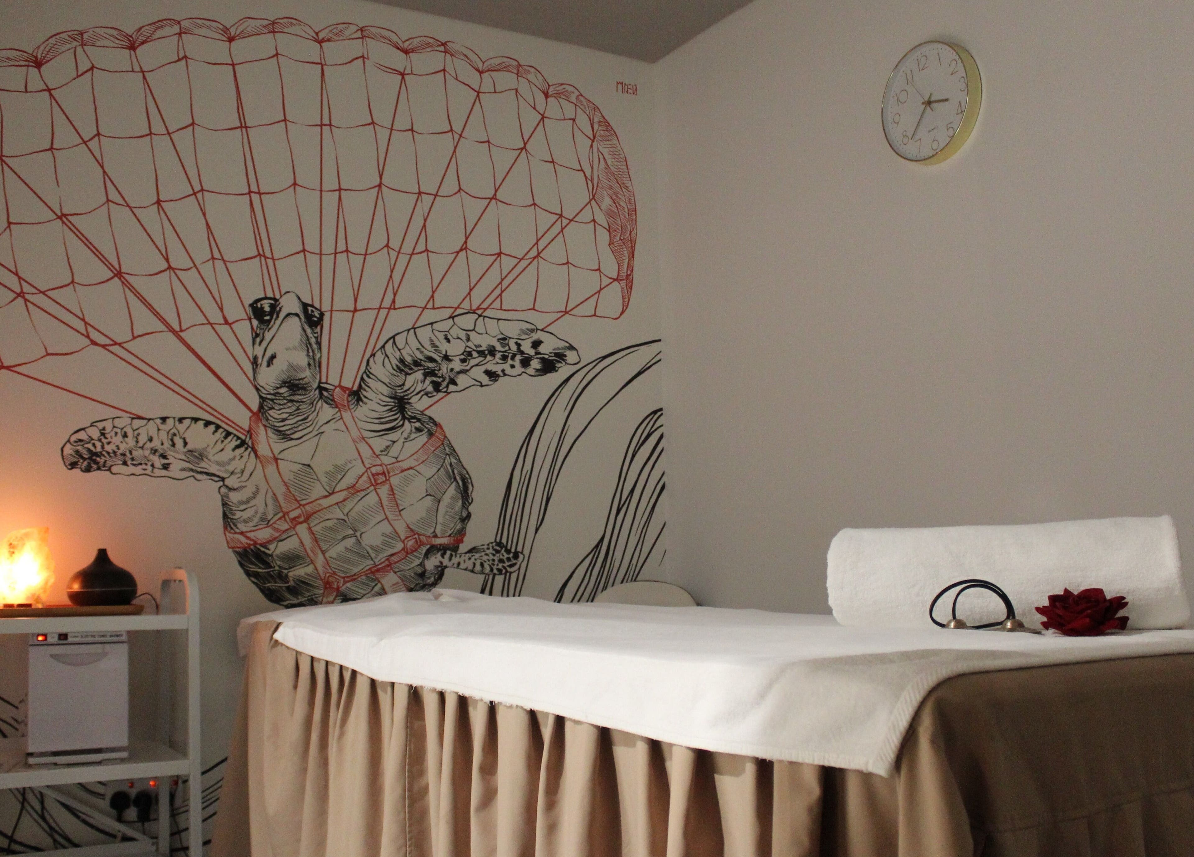 Relaxing spa room at DWS-Radisson Red Silicon Oasis in Dubai, Dubai, AE, featuring a turtle mural and massage bed.