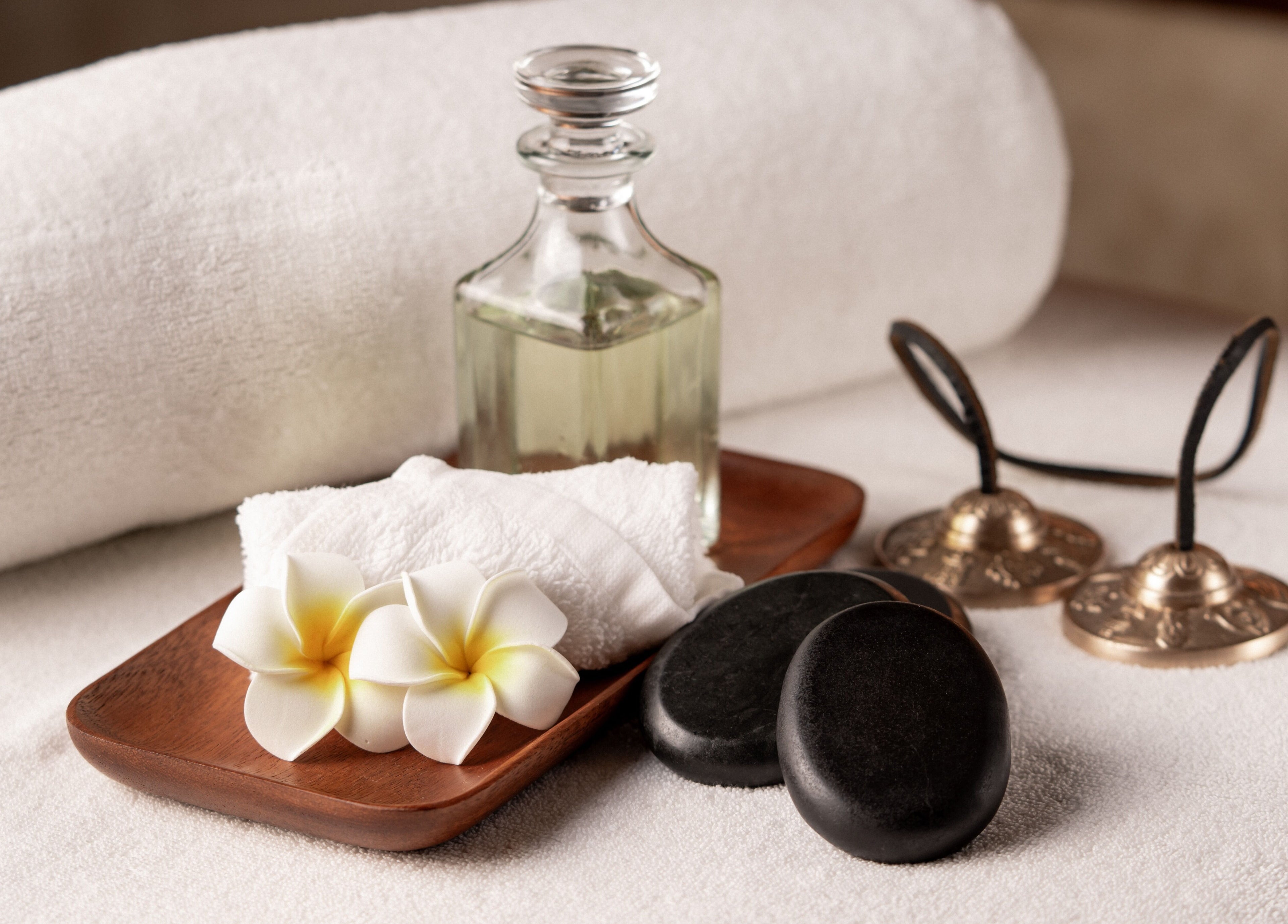 Relaxing spa setup at DWS-Damac Aykon City, Dubai, Dubai, AE with oils, flowers, and stones.