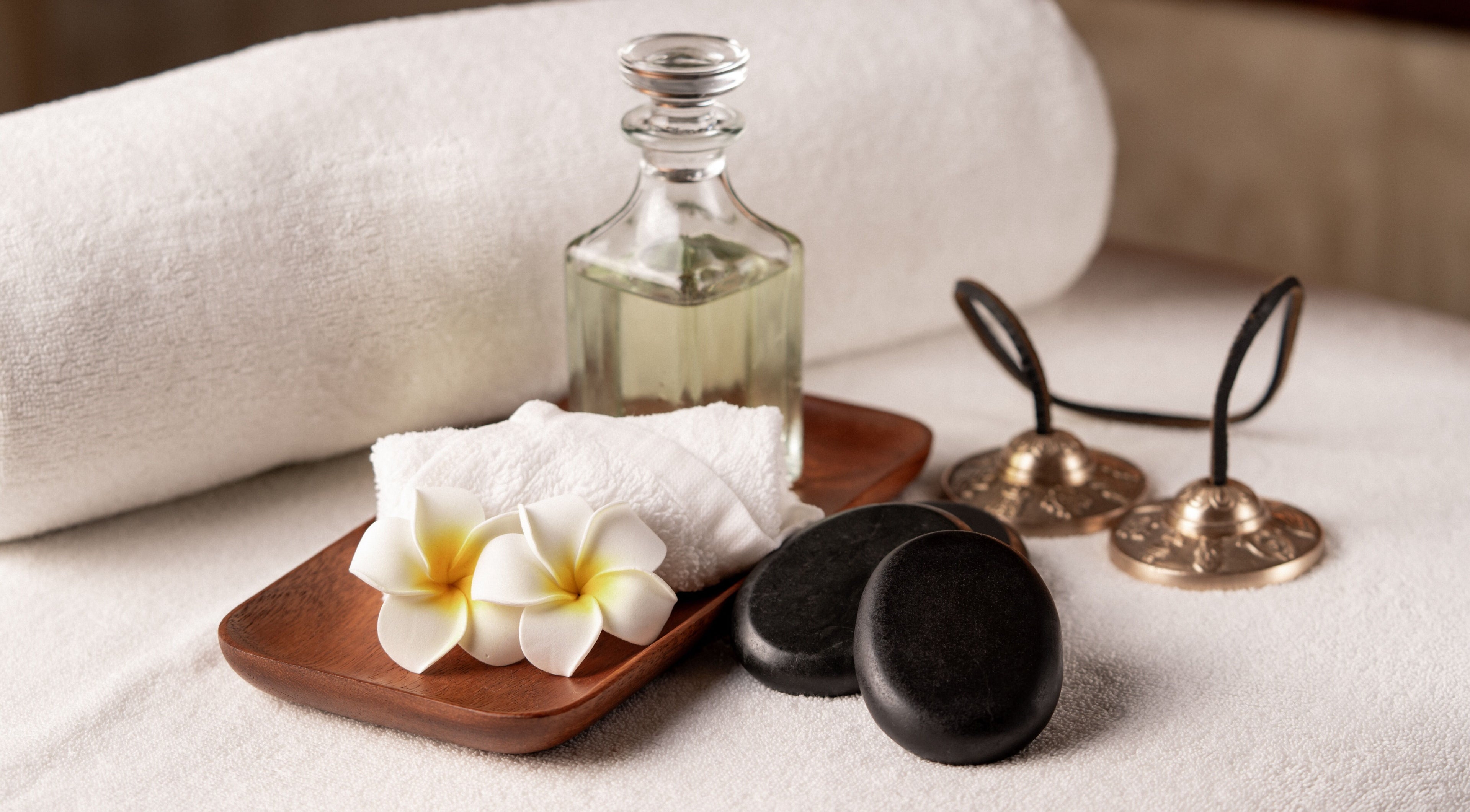 Relaxing spa setup at DWS-Damac Aykon City, Dubai, Dubai, AE with oils, flowers, and stones.