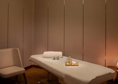 Luxurious massage room at DWS-Embassy Suites By Hilton, Dubai, Dubai, AE, featuring soft lighting and massage oils.