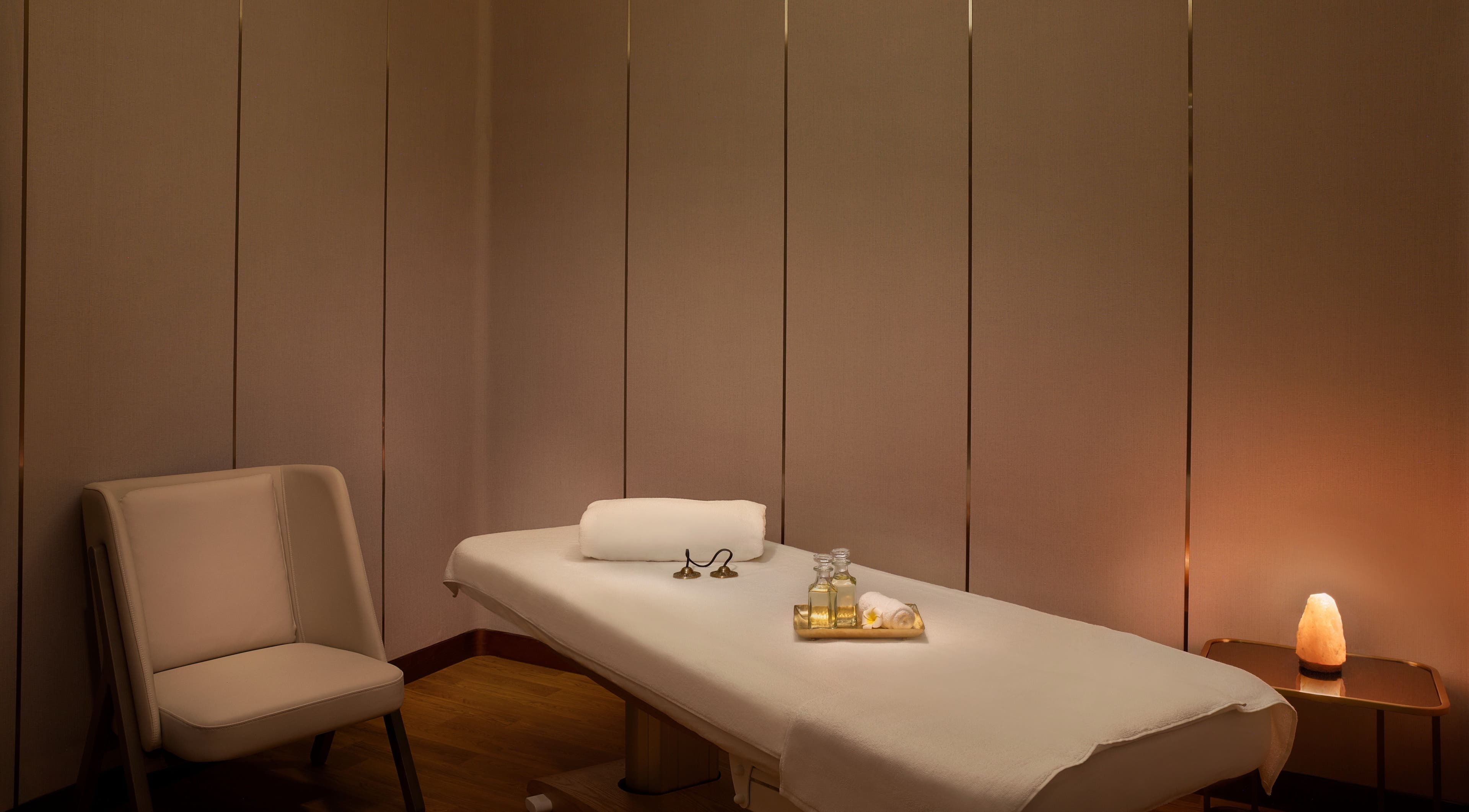 Luxurious massage room at DWS-Embassy Suites By Hilton, Dubai, Dubai, AE, featuring soft lighting and massage oils.