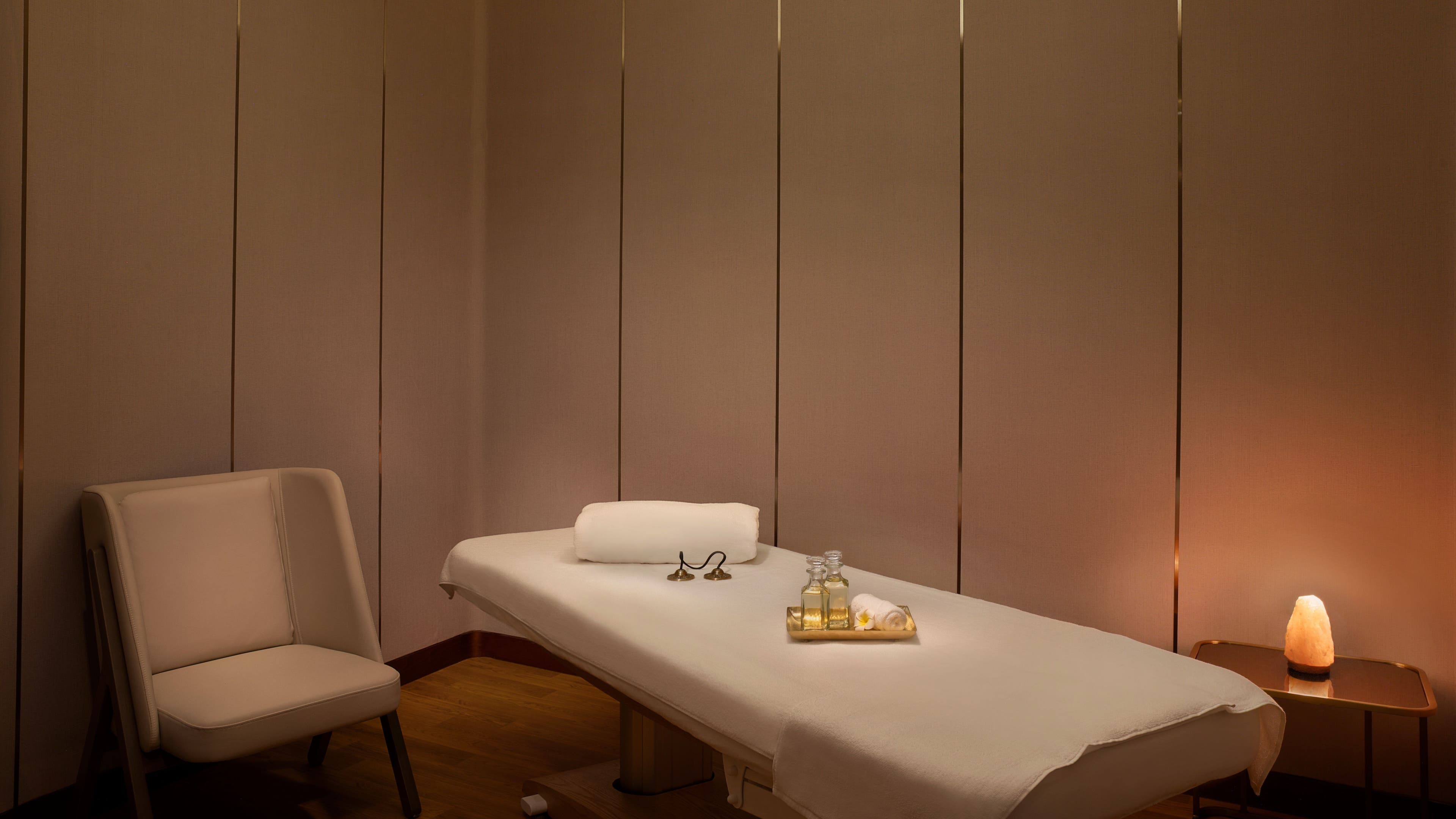 Luxurious massage room at DWS-Embassy Suites By Hilton, Dubai, Dubai, AE, featuring soft lighting and massage oils.