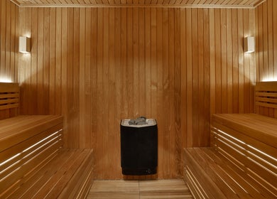 Relax in the serene sauna at DWS-Embassy Suites By Hilton, Dubai, Dubai, AE, offering calming wooden interiors.