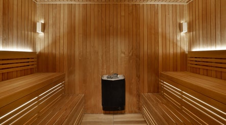 Relax in the serene sauna at DWS-Embassy Suites By Hilton, Dubai, Dubai, AE, offering calming wooden interiors.