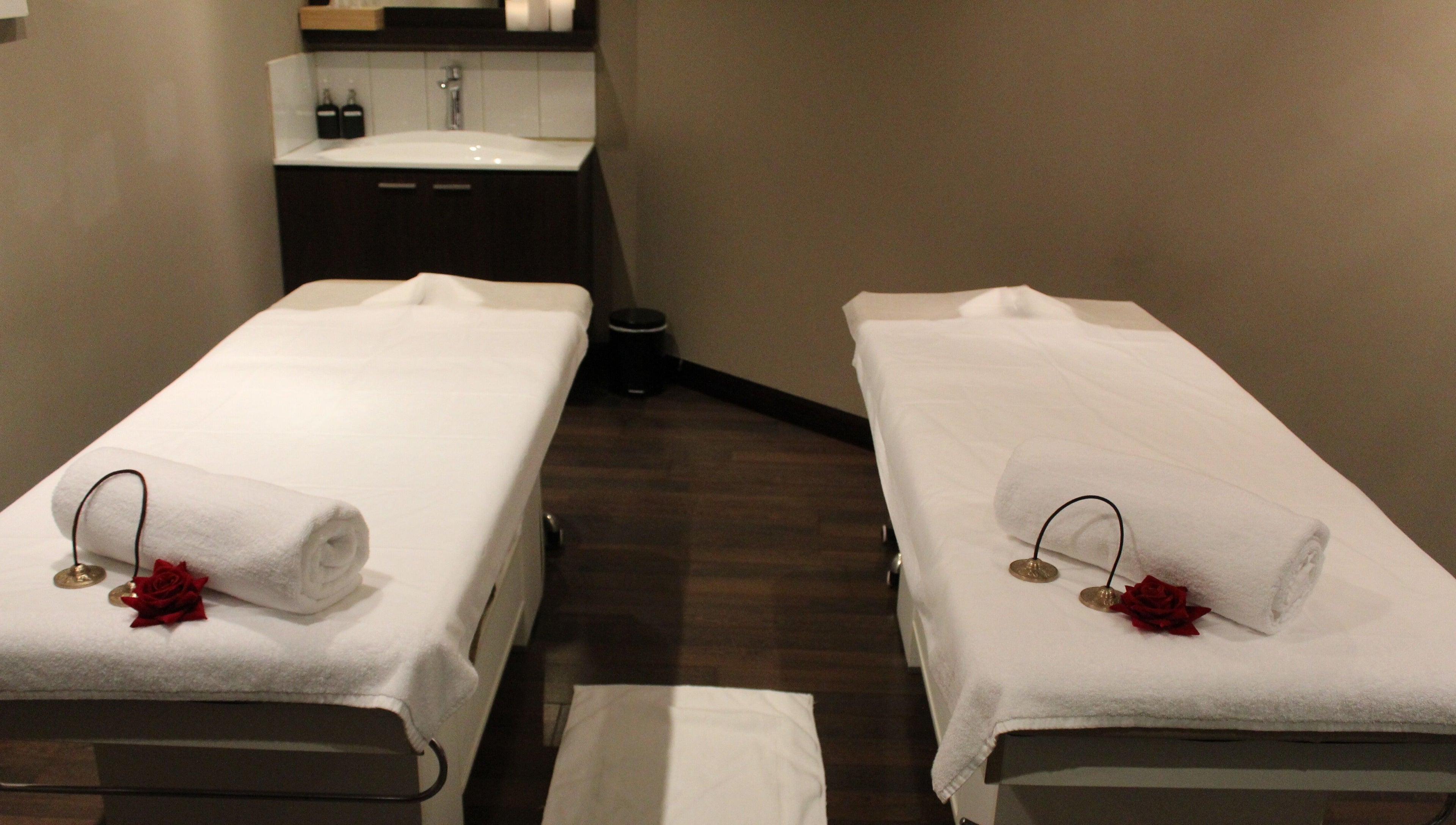 Relaxing massage room at DWS-Palm Jumeirah, Dubai, AE, offering a peaceful escape with twin beds and ambient lighting.