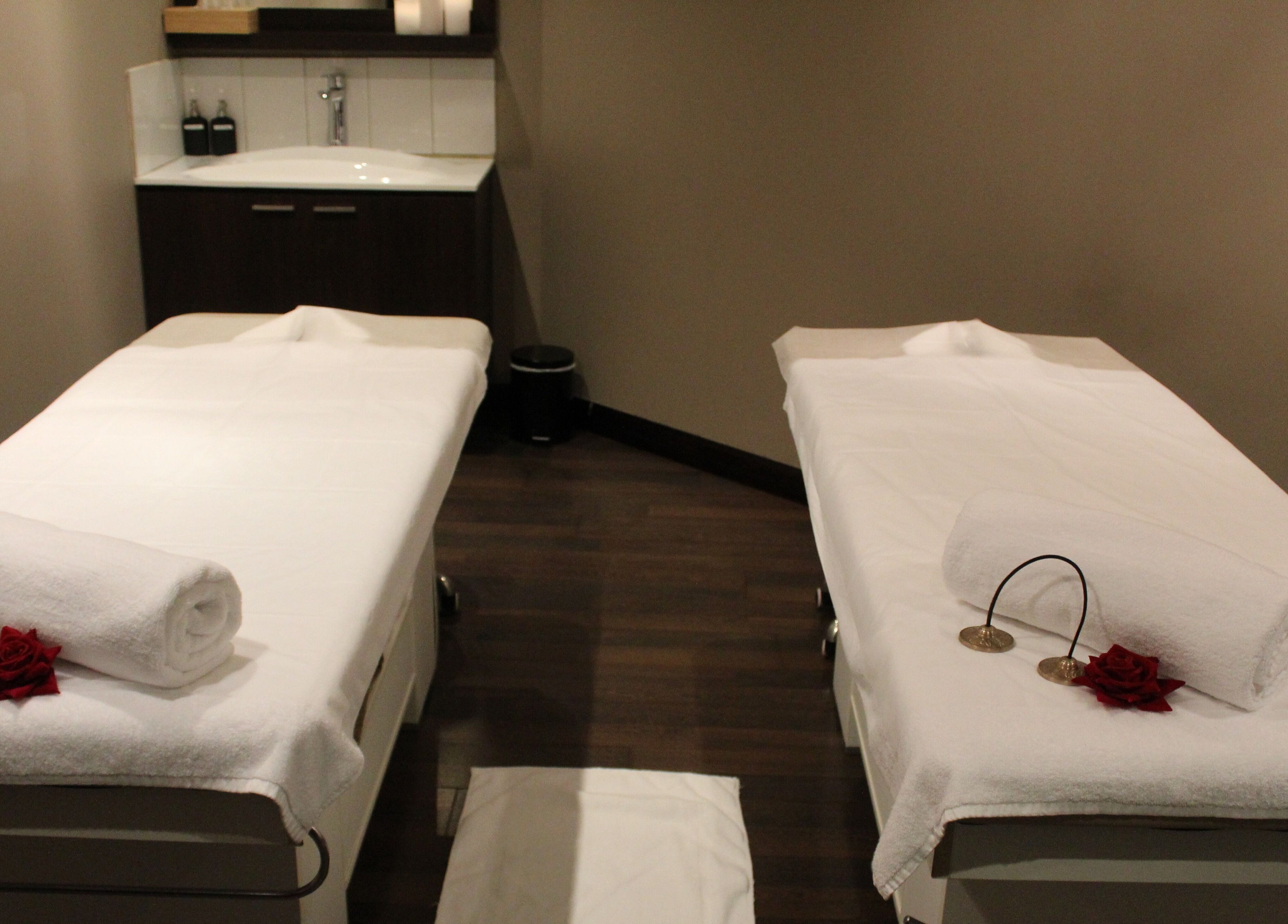 Relaxing massage room at DWS-Palm Jumeirah, Dubai, AE, offering a peaceful escape with twin beds and ambient lighting.