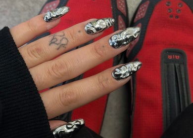 Stylish chrome nail art at Suki Nailz, London, England, GB, showcasing unique metallic 3D designs.
