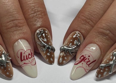 Intricate nail art with metallic accents at Suki Nailz in London, England, GB.