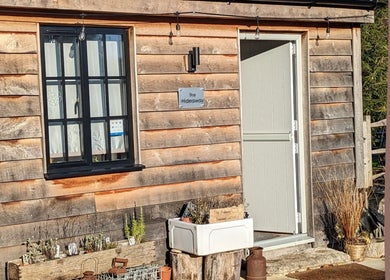 Entrance to Louise Palmer Holistics in Southampton, England, GB showcasing a rustic wooden cabin exterior.