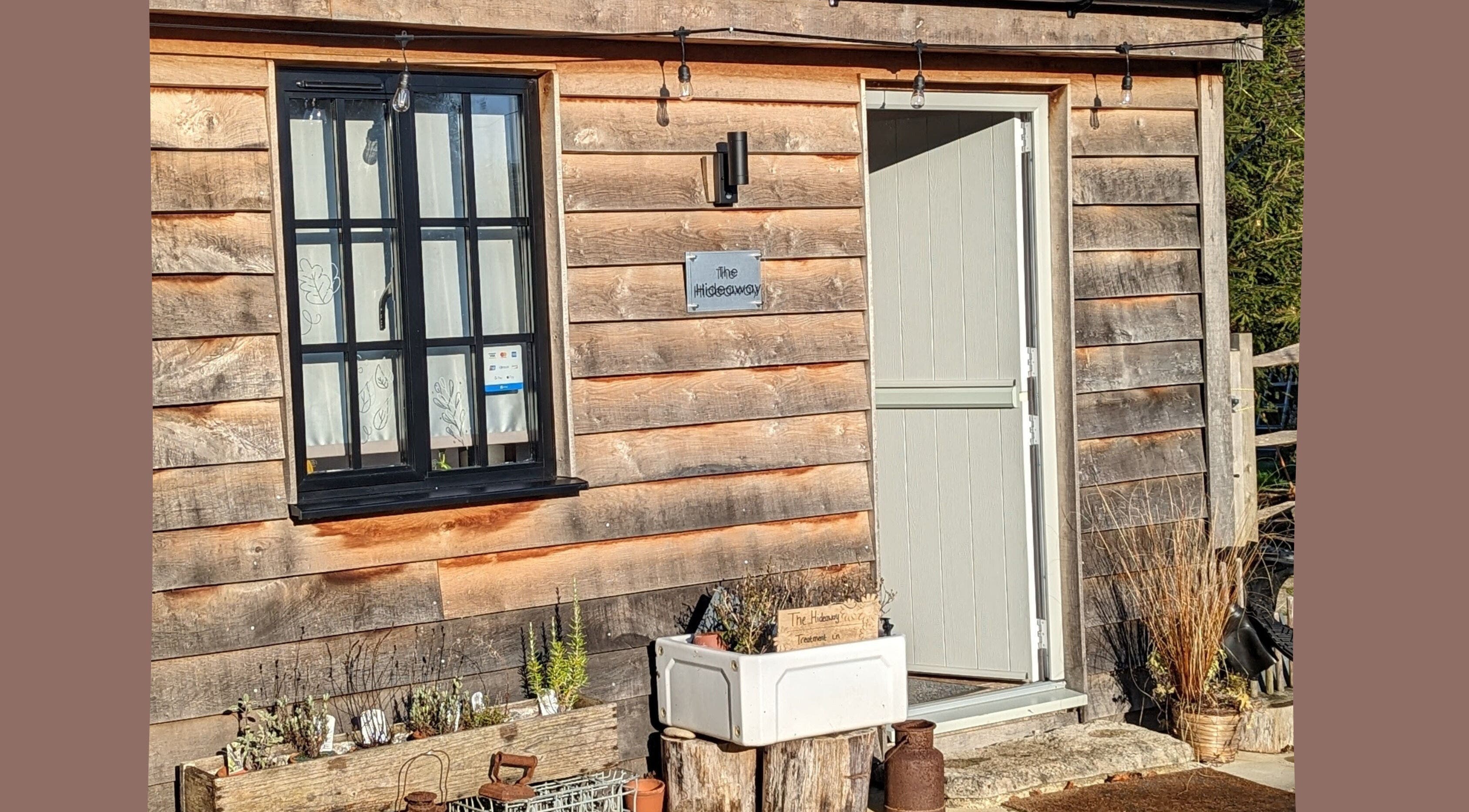Entrance to Louise Palmer Holistics in Southampton, England, GB showcasing a rustic wooden cabin exterior.