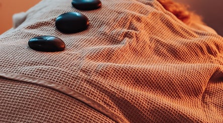 Hot stones on a massage table at Louise Palmer Holistics, Southampton, England, GB for ultimate relaxation.