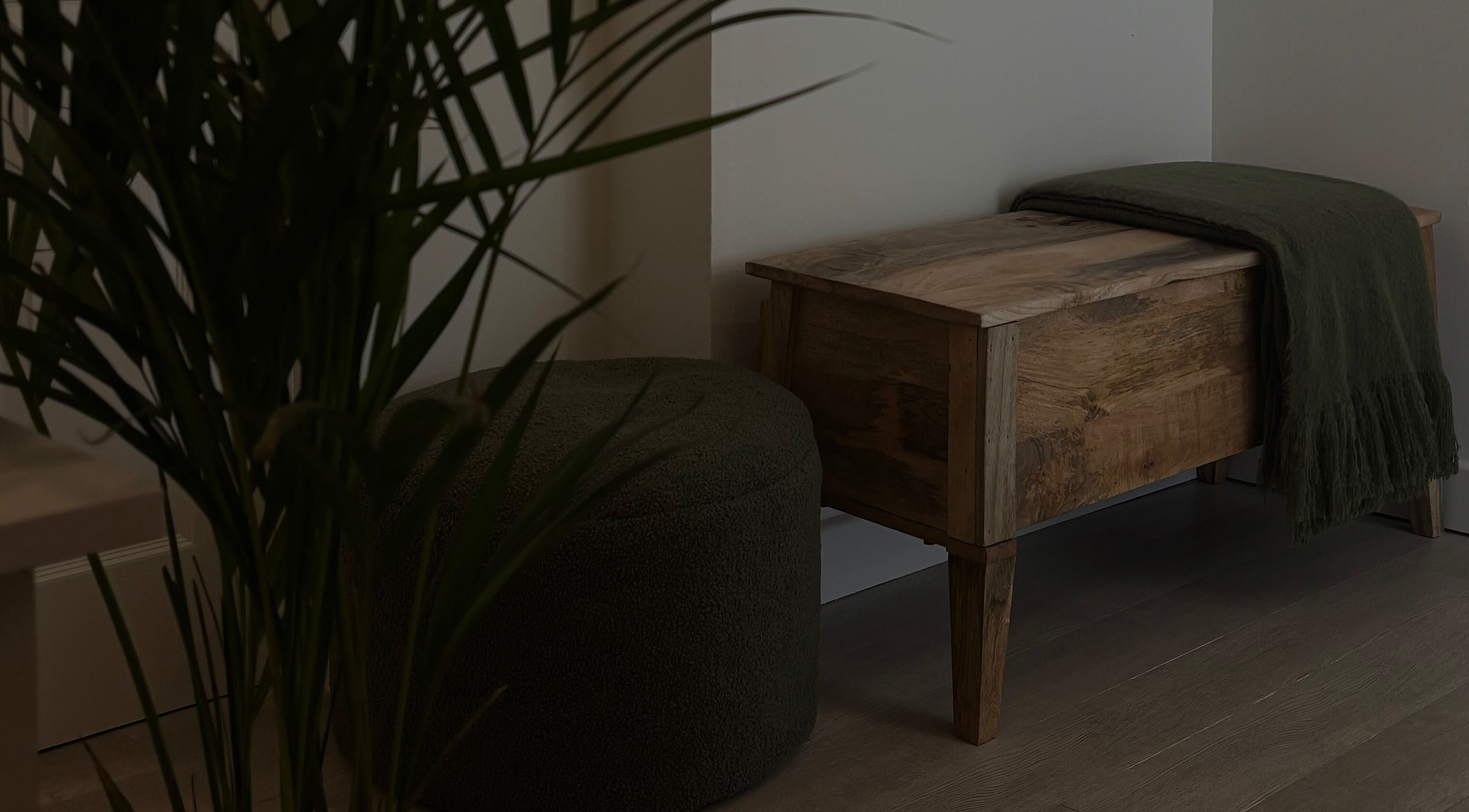Cozy seating area at Beauty by Livi, Rugby, England, GB, featuring a wooden bench and green decor.