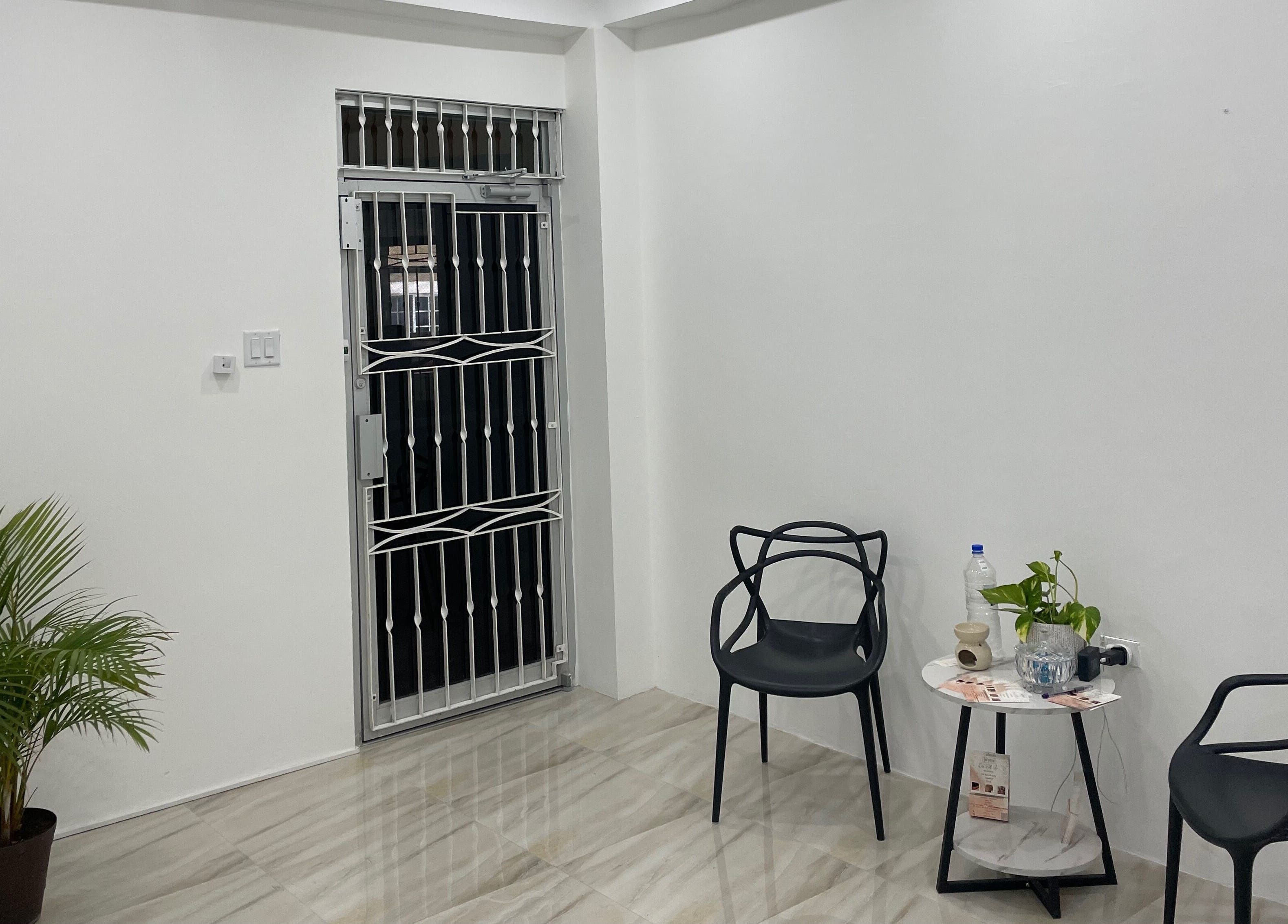 Inviting seating area at Jahzeni Beauty Lounge, Runaway Bay, St. Ann Parish, JM with chairs and potted plant.