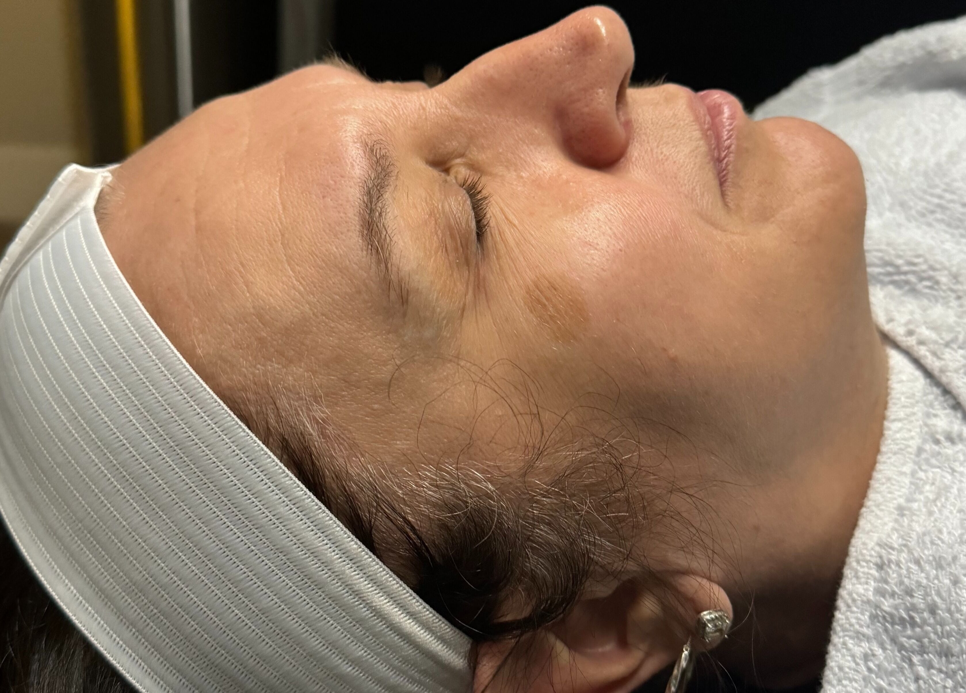 Client enjoying a facial at Wild Winx Esthetics, Phoenix, Arizona, US, showcasing relaxation and skin care.