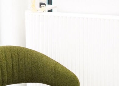 Elegant reception area with green chair at Cosmo Medispa, Ramsgate, New South Wales, AU.