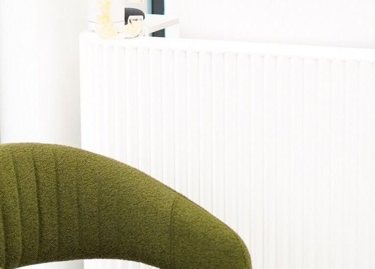Elegant reception area with green chair at Cosmo Medispa, Ramsgate, New South Wales, AU.