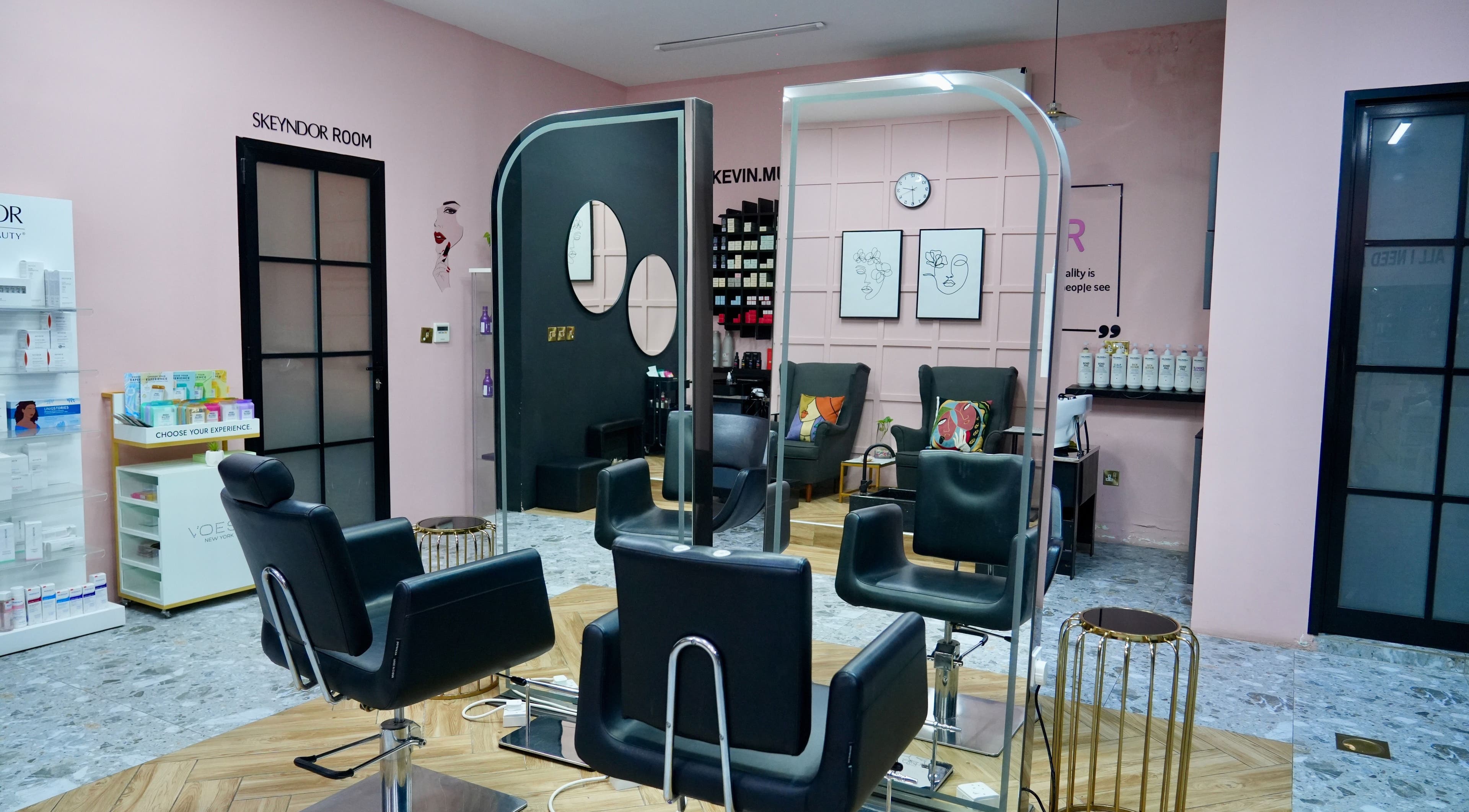 Modern salon interior at Topone Salon & Spa, Muscat, Muscat Governorate, OM with sleek black chairs and chic decor.