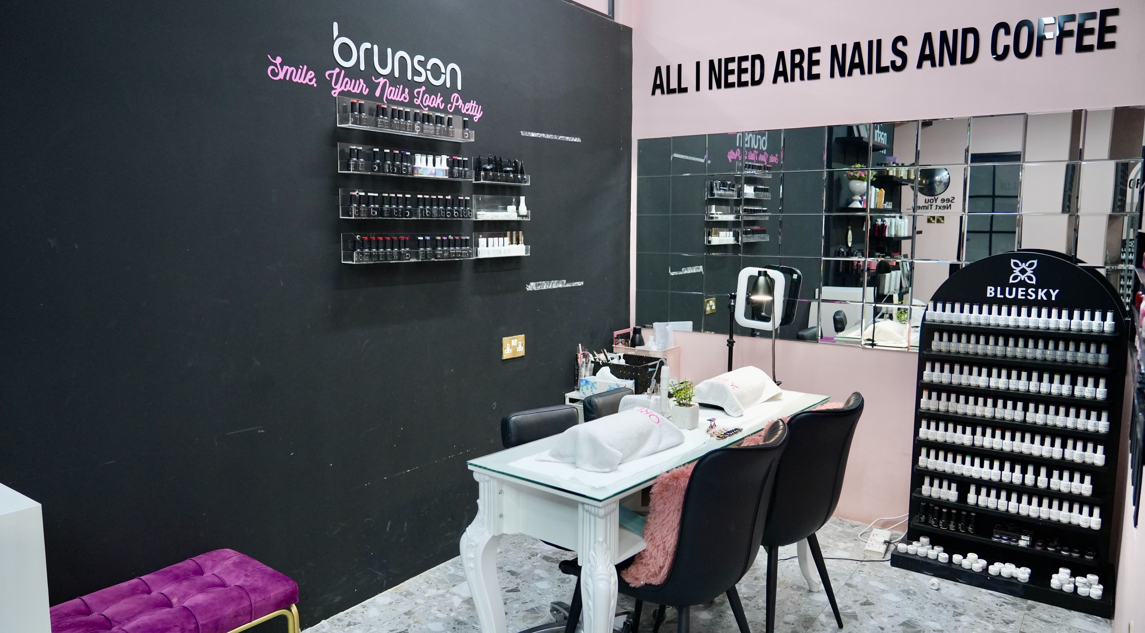 Nail station at Topone Salon & Spa in Muscat offers a stylish setting with nail polish displays.