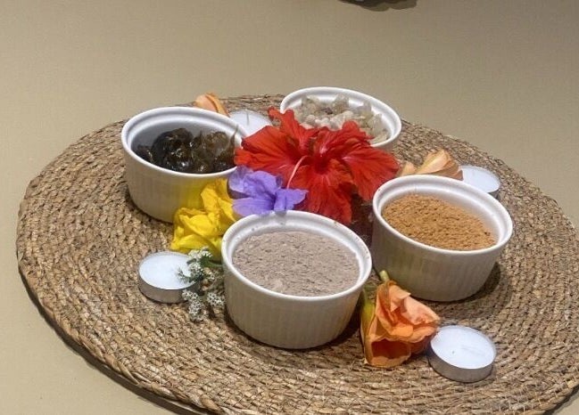 Herbal bowls and flowers at Galo Spa, صلالة, محافظة ظفار, OM, enhancing tranquility and wellness.