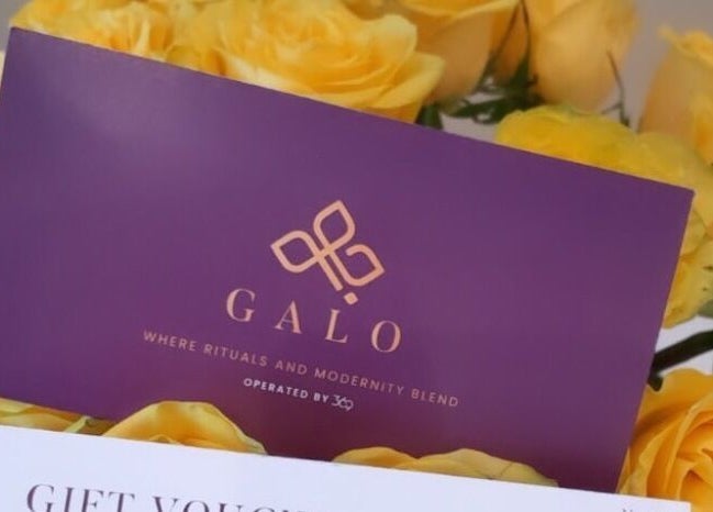Galo Spa gift voucher amid vibrant yellow roses at صلالة, محافظة ظفار, OM.