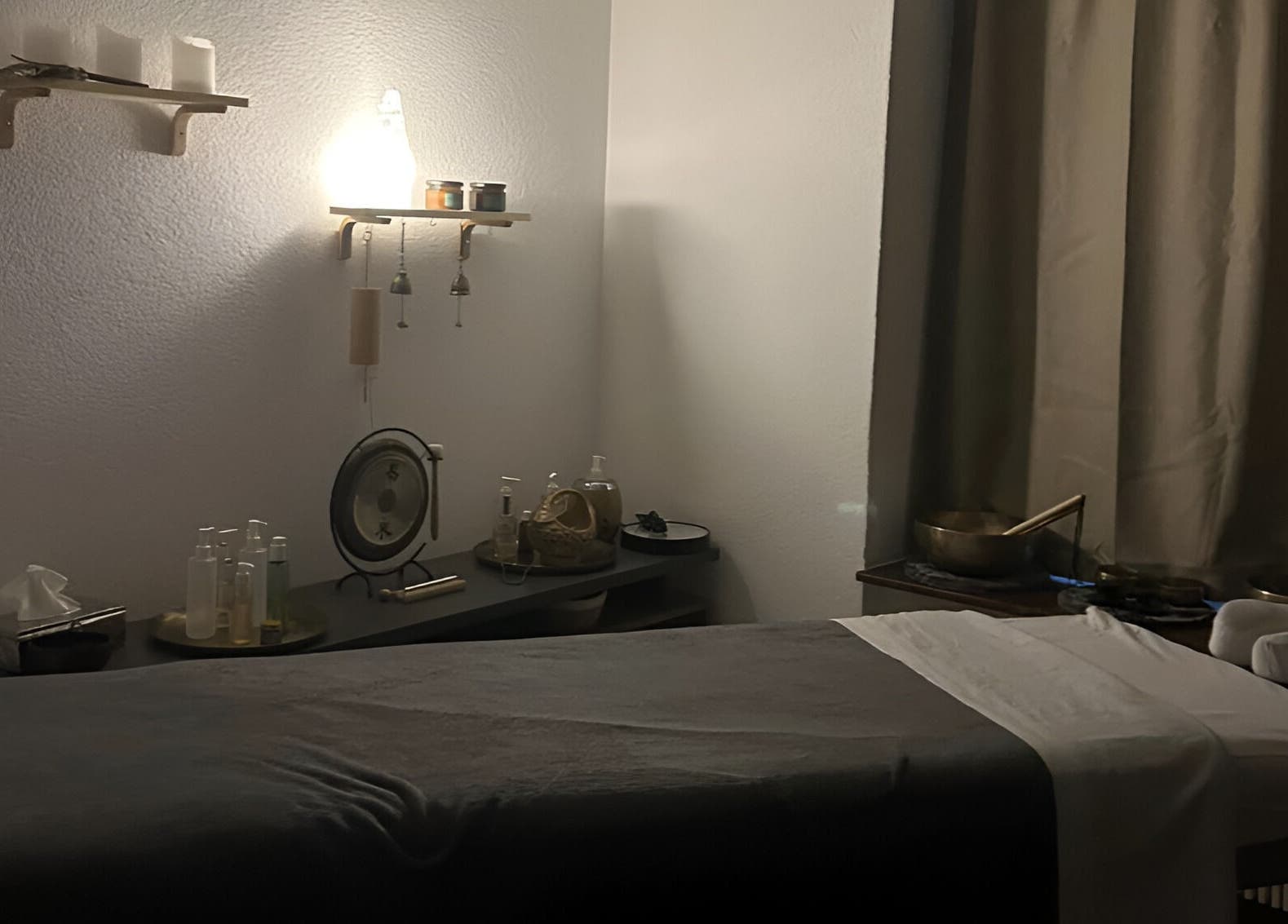 Relaxing massage room at Izzy's Studio, Val De Bagnes, Valais, CH, featuring dim lighting and wellness decor.