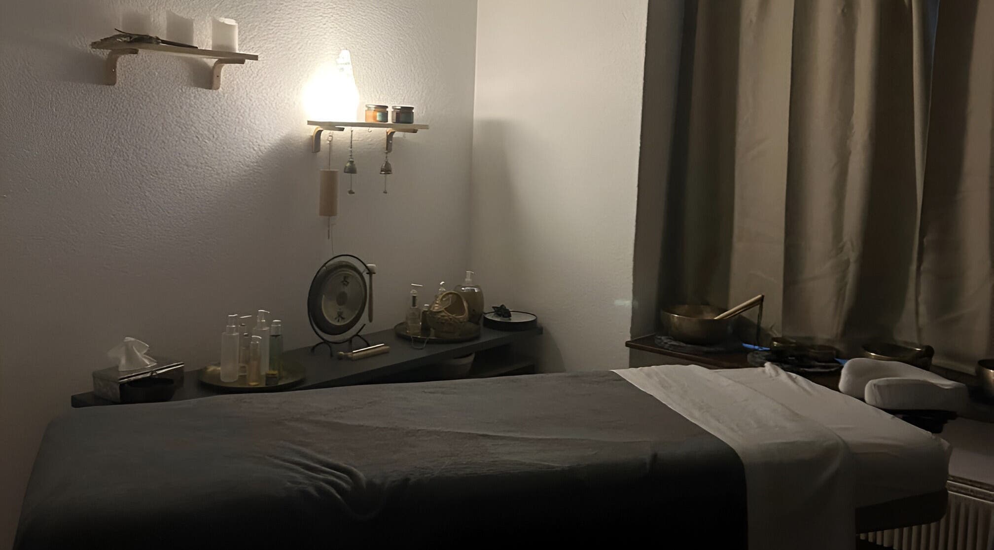 Relaxing massage room at Izzy's Studio, Val De Bagnes, Valais, CH, featuring dim lighting and wellness decor.