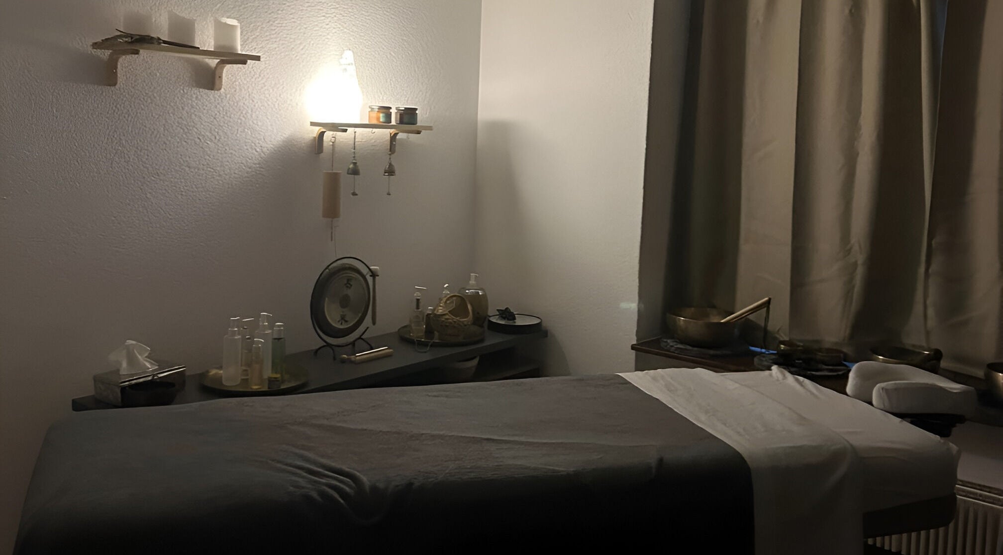 Relaxing massage room at Izzy's Studio, Val De Bagnes, Valais, CH, featuring dim lighting and wellness decor.