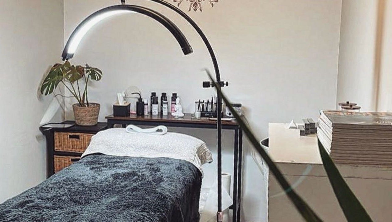 Cozy therapy room at PURE BEAUTY in Weston Super Mare, England, GB, featuring a massage table and soft lighting.