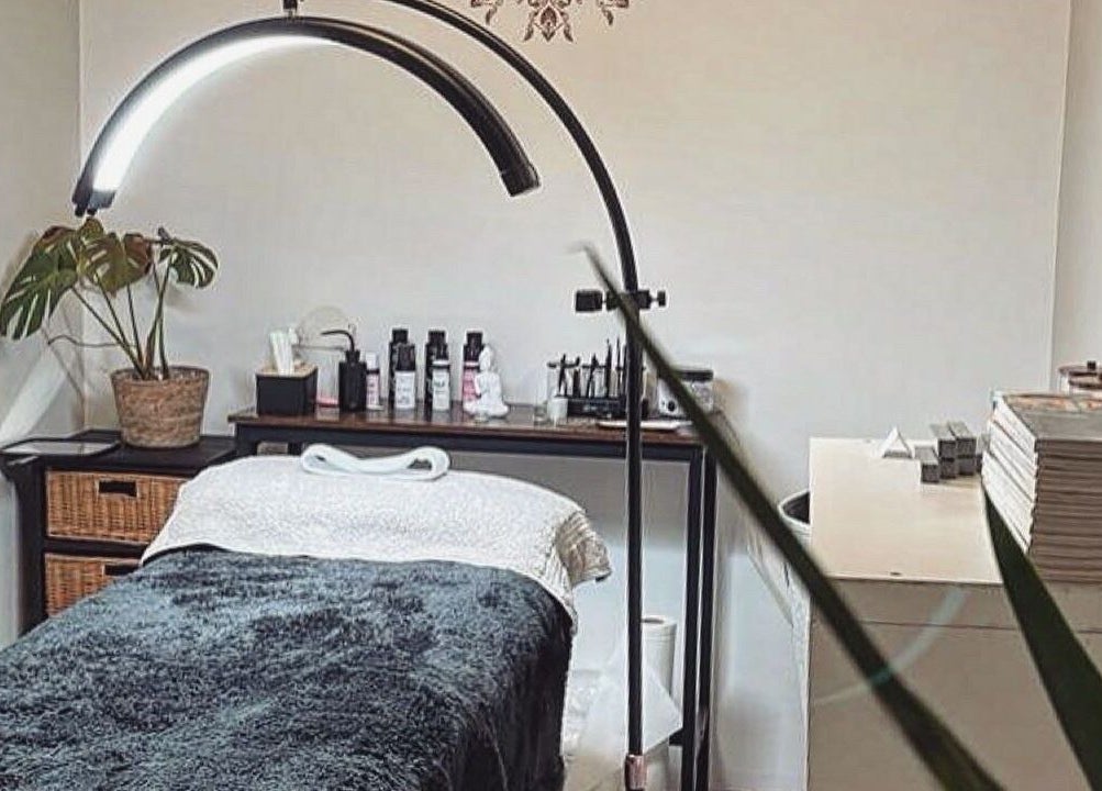 Cozy therapy room at PURE BEAUTY in Weston Super Mare, England, GB, featuring a massage table and soft lighting.