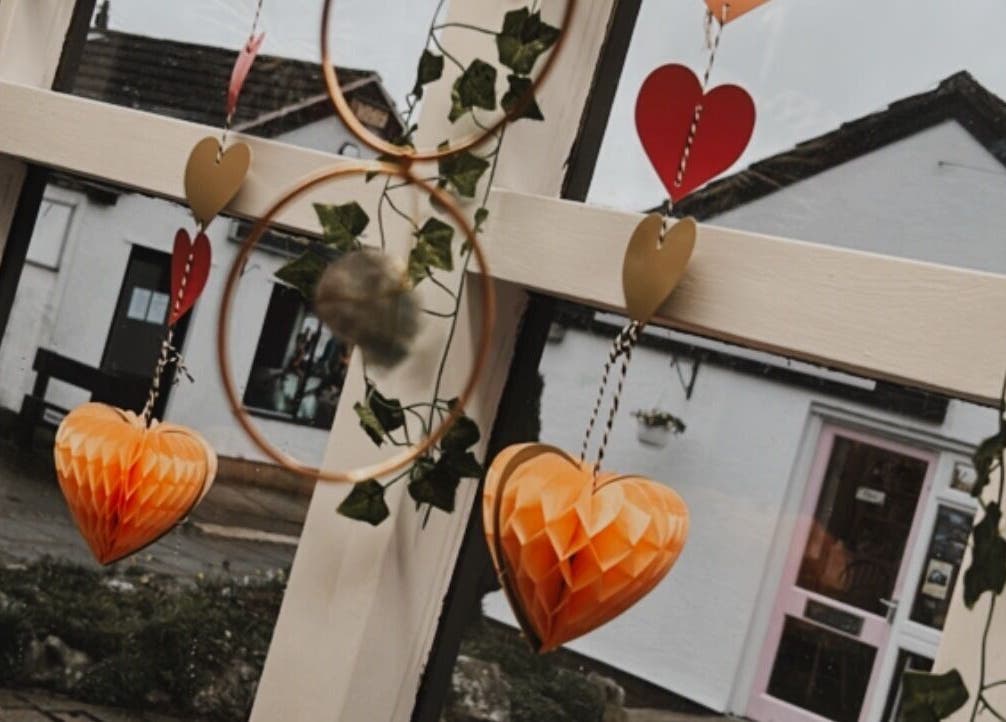 Heart ornaments and greenery in window at The Soul Sanctuary, Garstang, England, GB.