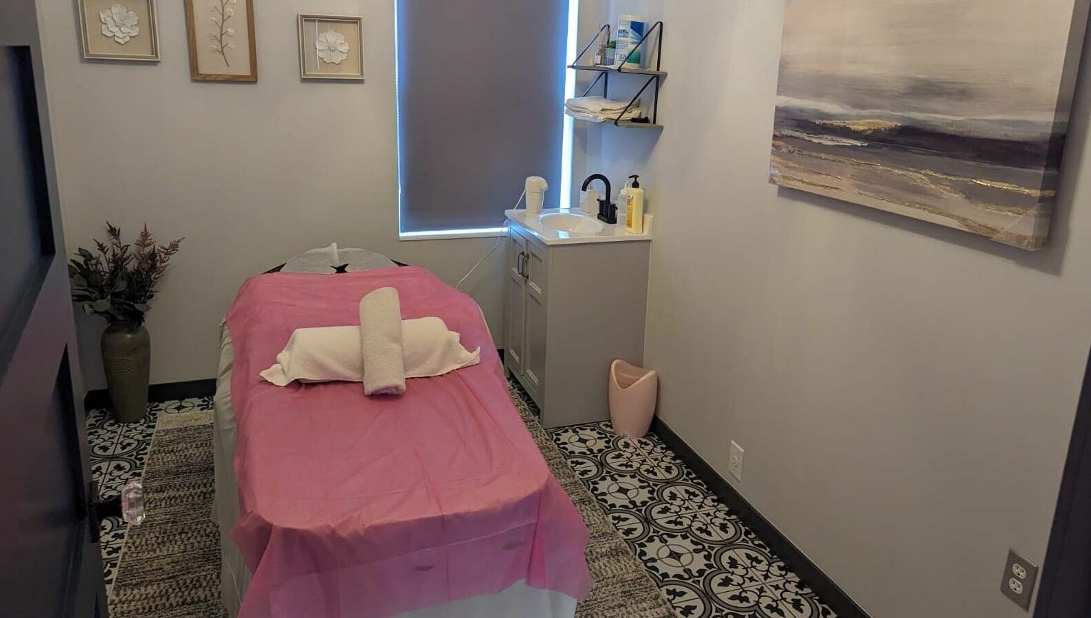 Relaxing massage room at Tropical Touch Polaris, Columbus, Ohio, US with pink sheets and elegant decor.