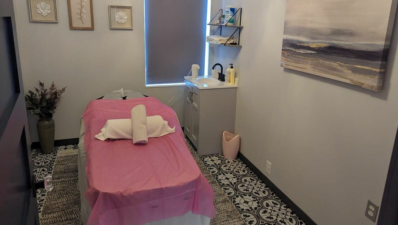 Relaxing massage room at Tropical Touch Polaris, Columbus, Ohio, US with pink sheets and elegant decor.