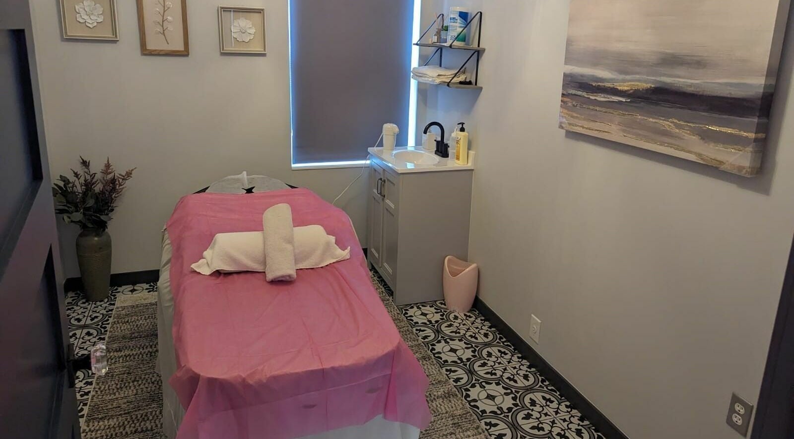 Relaxing massage room at Tropical Touch Polaris, Columbus, Ohio, US with pink sheets and elegant decor.