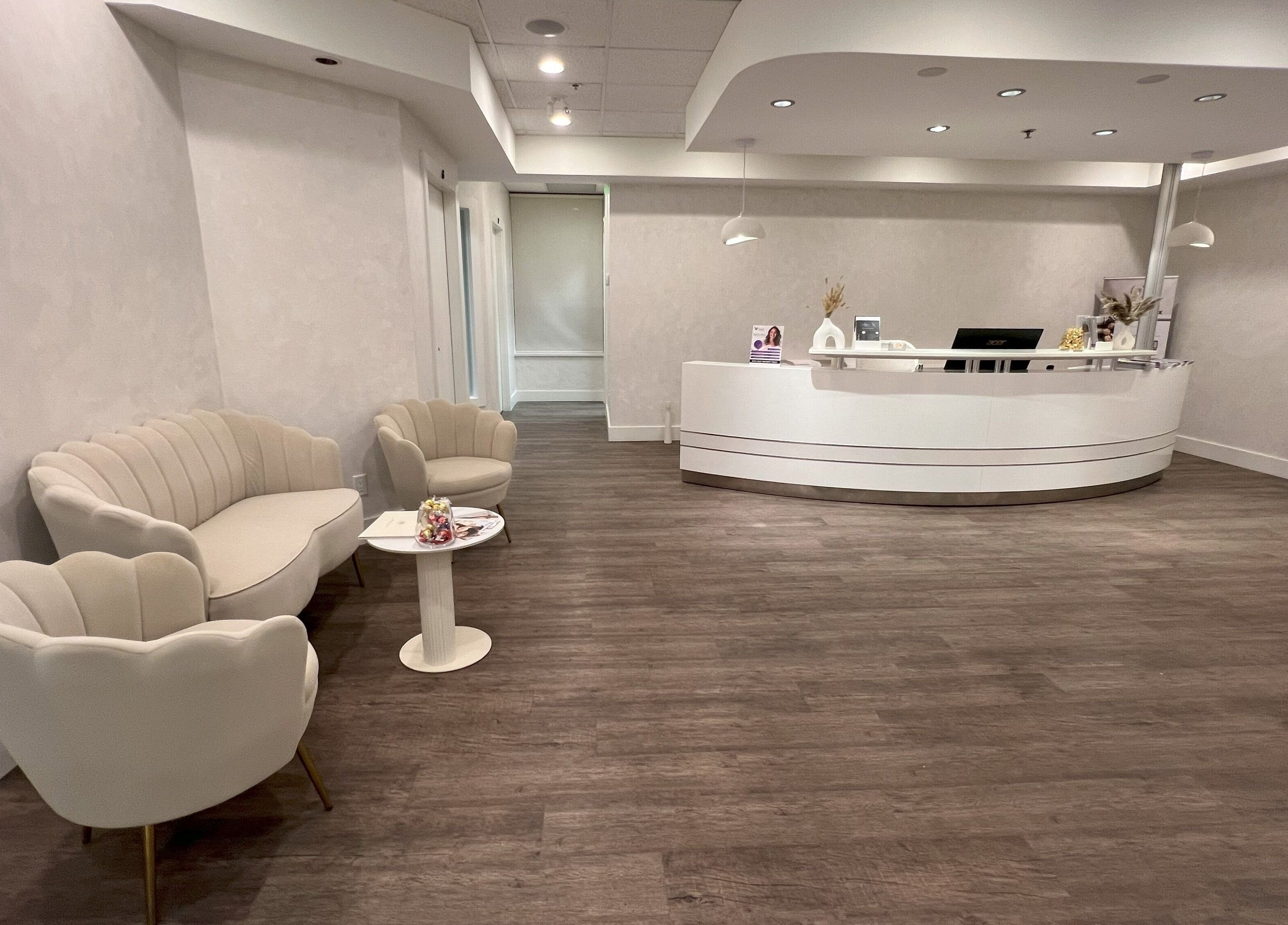 Elegant reception area at Oasis Aesthetics Spa - Marine, West Vancouver, BC with modern decor and cozy seating.
