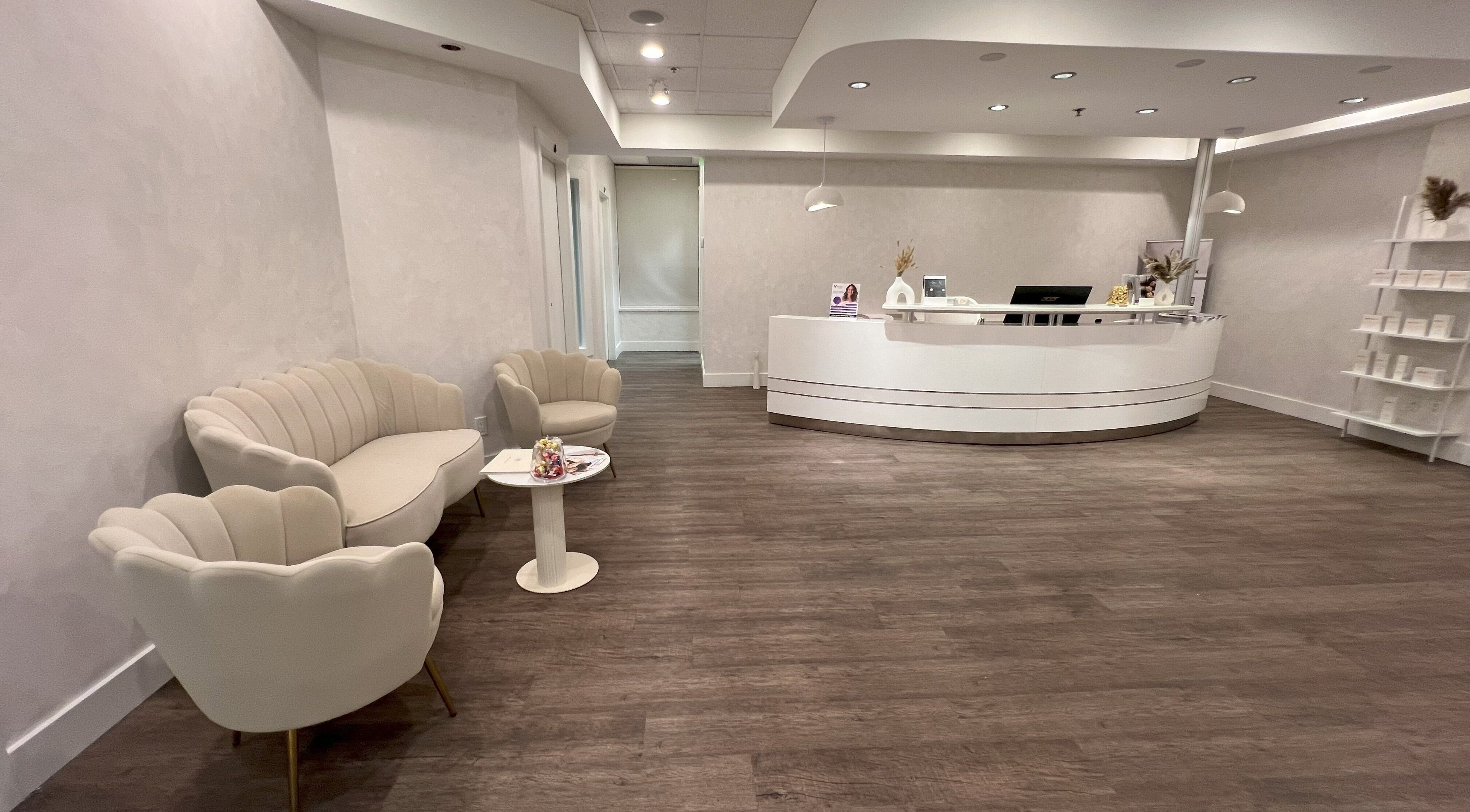 Elegant reception area at Oasis Aesthetics Spa - Marine, West Vancouver, BC with modern decor and cozy seating.