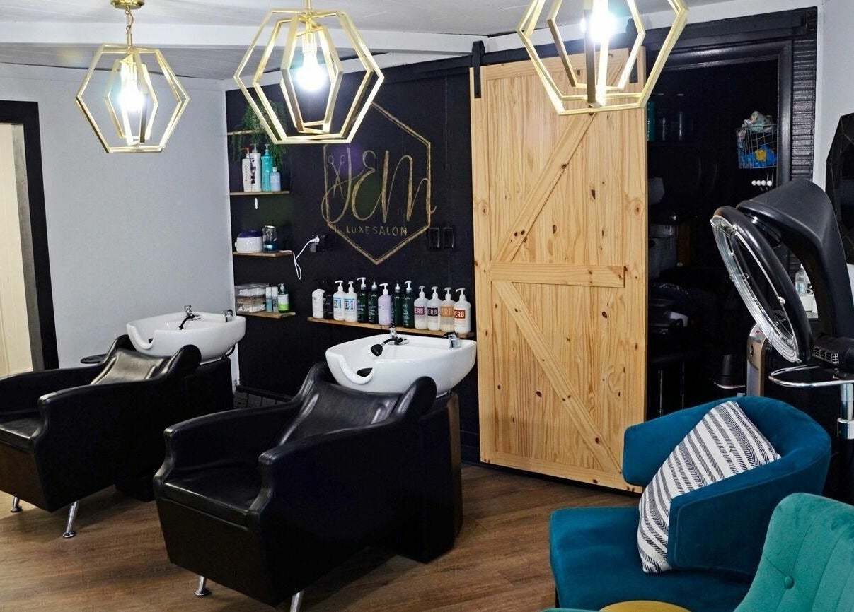 Luxurious interior of JEM Luxe Salon LLC, Coloma, Michigan, US featuring modern chairs and stylish lighting.