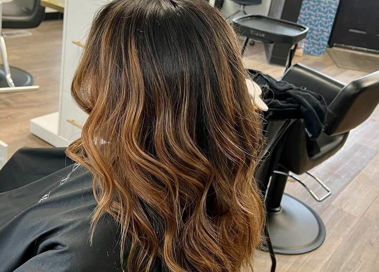 Elegant wavy hairstyle by JEM Luxe Salon LLC in Coloma, Michigan, US. Luxurious salon ambiance.