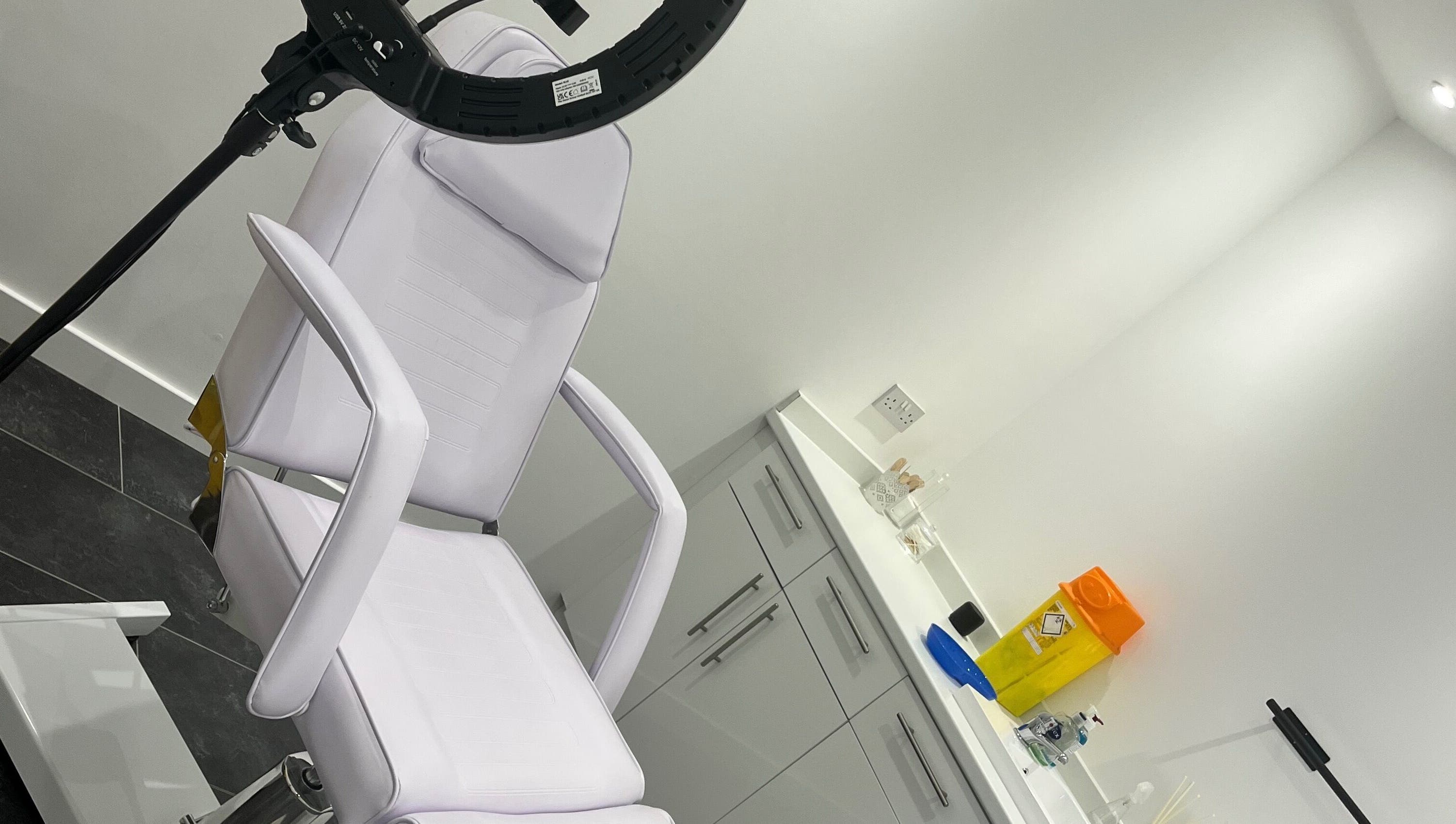 Modern treatment room at SPMU & Lashes by Klaudia, Livingston, Scotland, GB, showcasing a stylish chair and equipment.