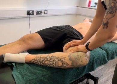 Therapist massages tattooed leg at High Pavement House, Sutton-in-Ashfield, England, GB.