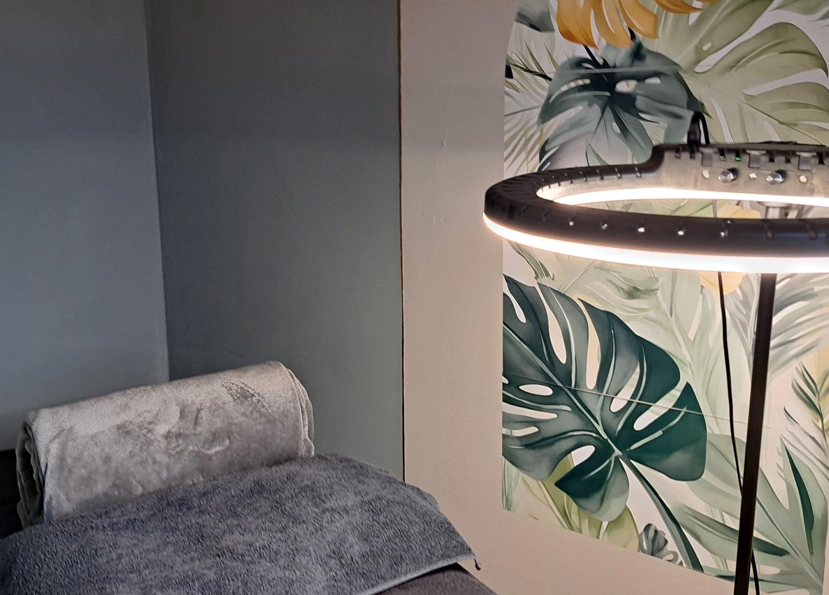 Cozy treatment room at Le Lash and Brow Artist, Cape Town, with tropical decor and soft lighting.