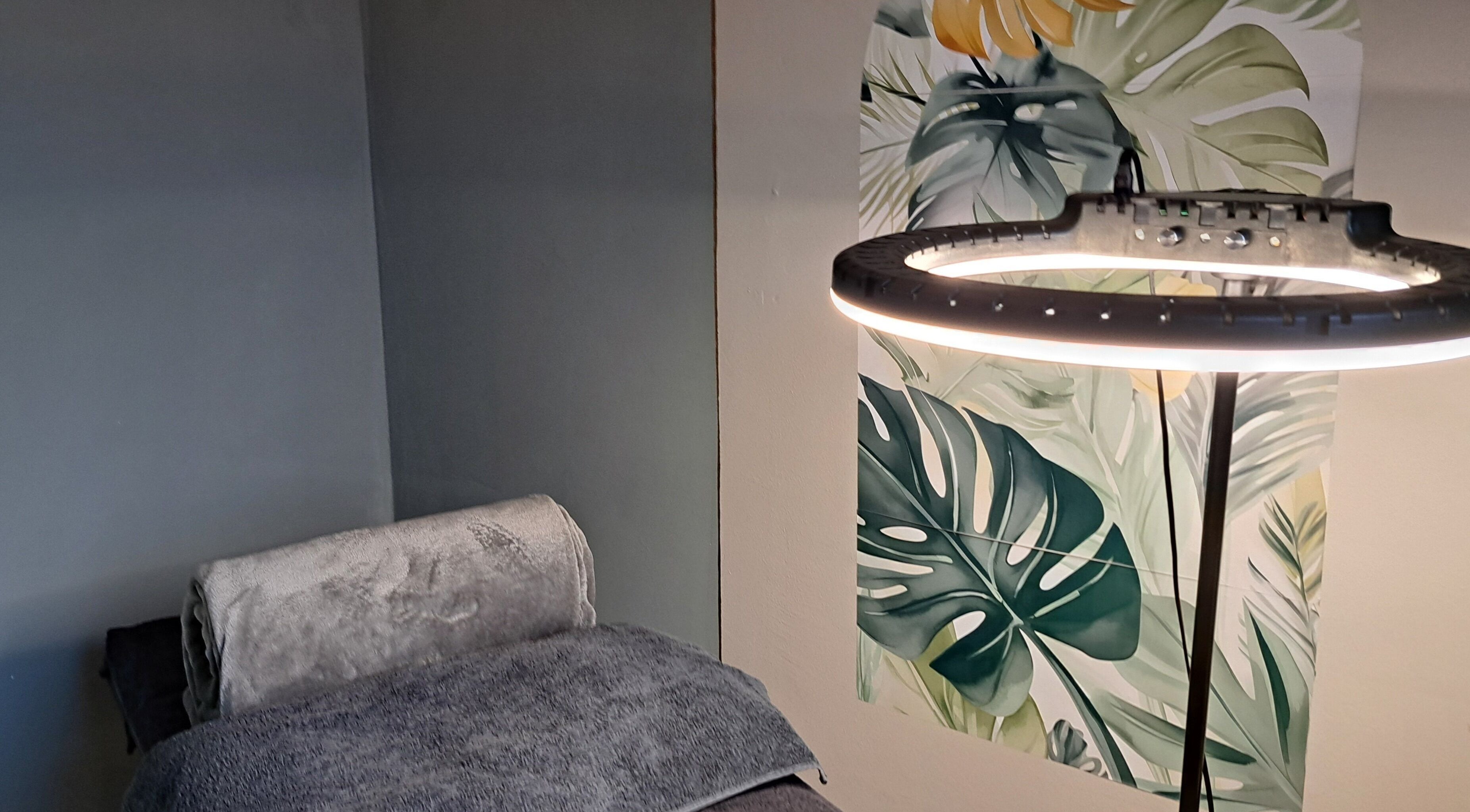 Cozy treatment room at Le Lash and Brow Artist, Cape Town, with tropical decor and soft lighting.