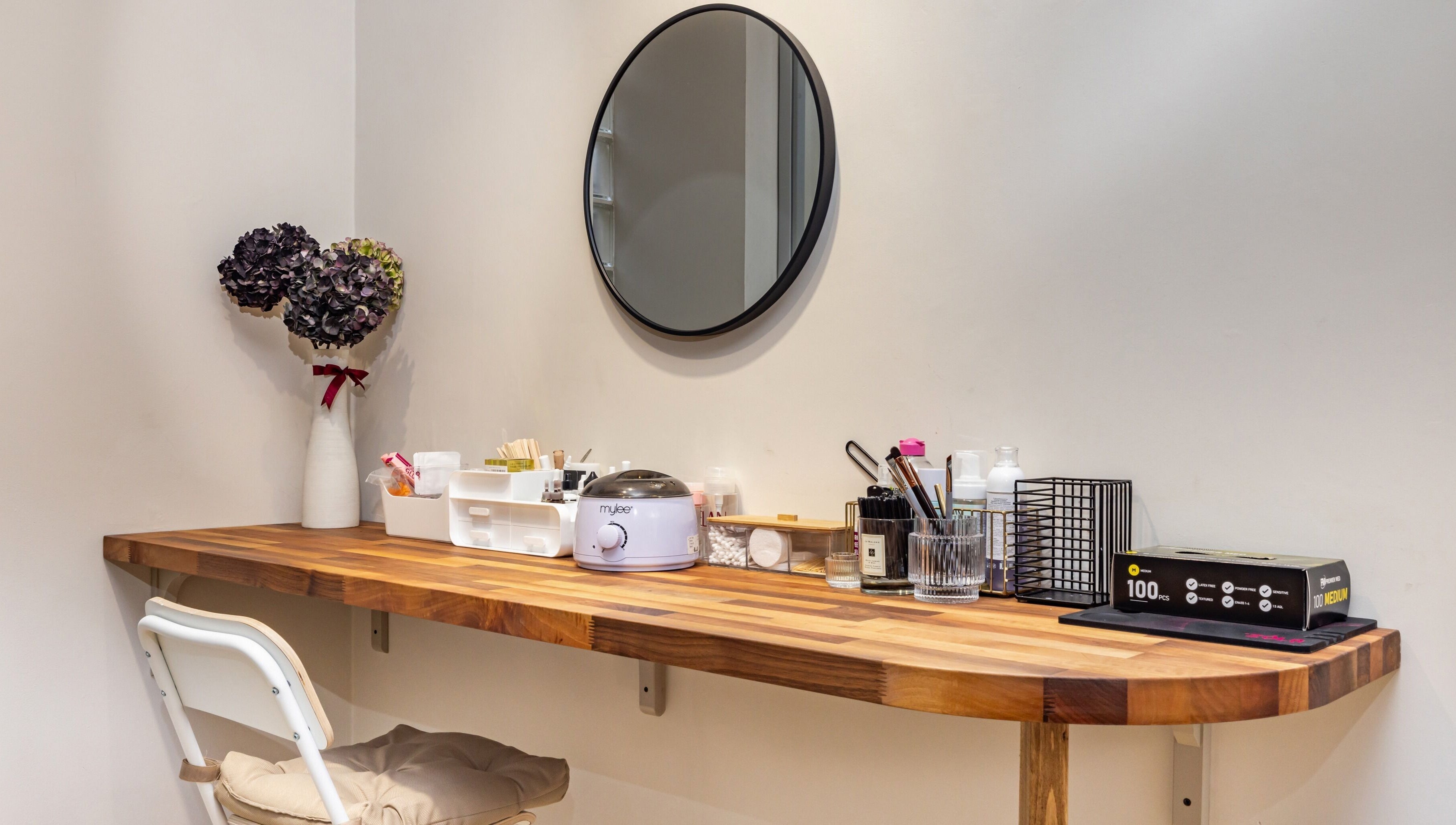 Chic nail station at Show Me Your Nails, London, England, GB, featuring a wooden desk and beauty products.